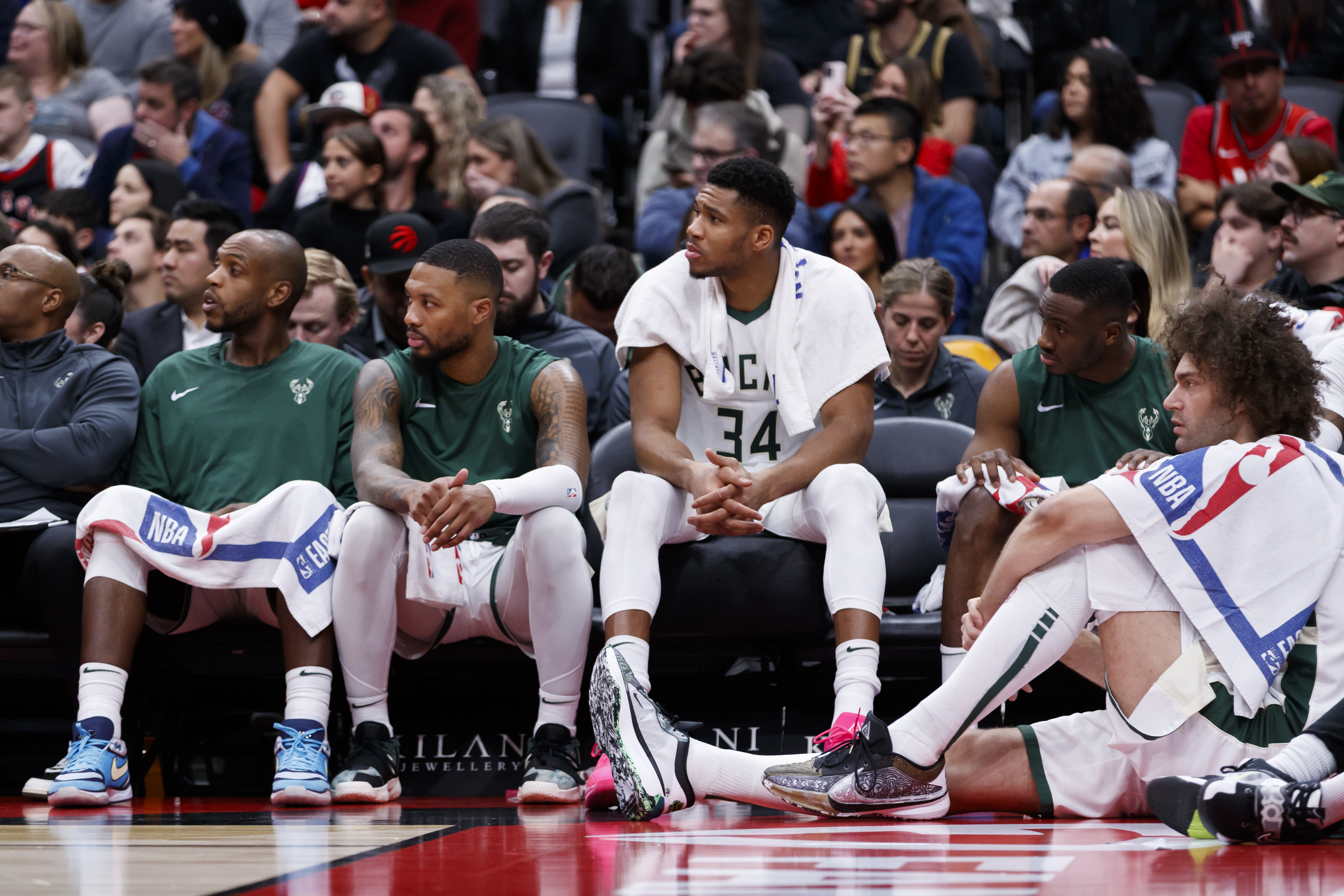 TORONTO, CANADA - NOVEMBER 1: Khris Middleton #22,  Damian Lillard #0 and Giannis Antetokounmpo #34 of the Milwaukee Bucks on the bench uring the second half of their NBA game against the Toronto Raptors at Scotiabank Arena on November 1, 2023 in Toronto, Canada. NOTE TO USER: User expressly acknowledges and agrees that, by downloading and or using this photograph, User is consenting to the terms and conditions of the Getty Images License Agreement. (Photo by Cole Burston/Getty Images)