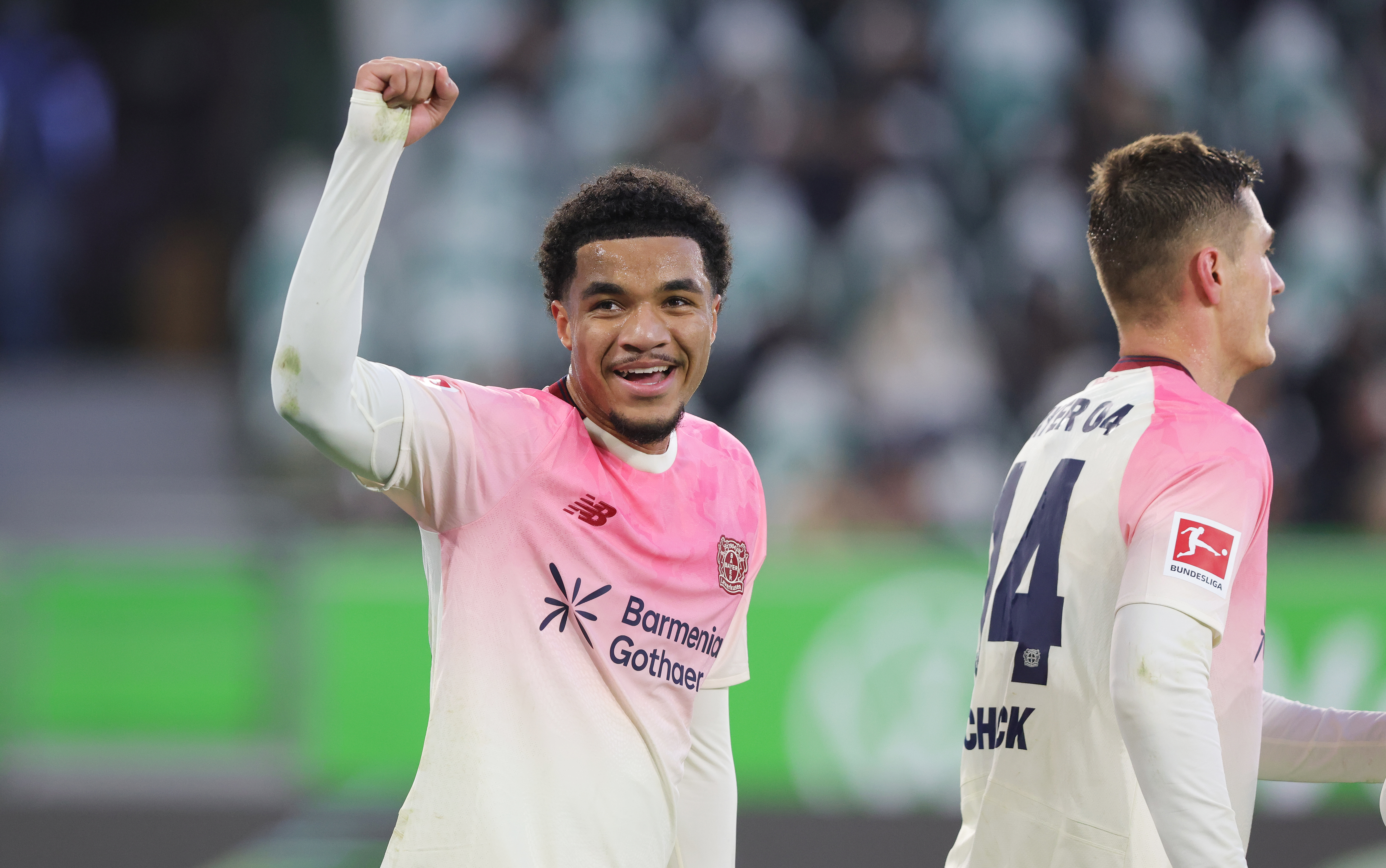 WOLFSBURG, GERMANY - NOVEMBER 22: Malik Tillman of Bayer Leverkusen (L) celebrates after scoring his team's third goal during the Bundesliga match between VfL Wolfsburg and Bayer 04 Leverkusen at Volkswagen Arena on November 22, 2025 in Wolfsburg, Germany. (Photo by Sebastian El-Saqqa - firo sportphoto/Getty Images)