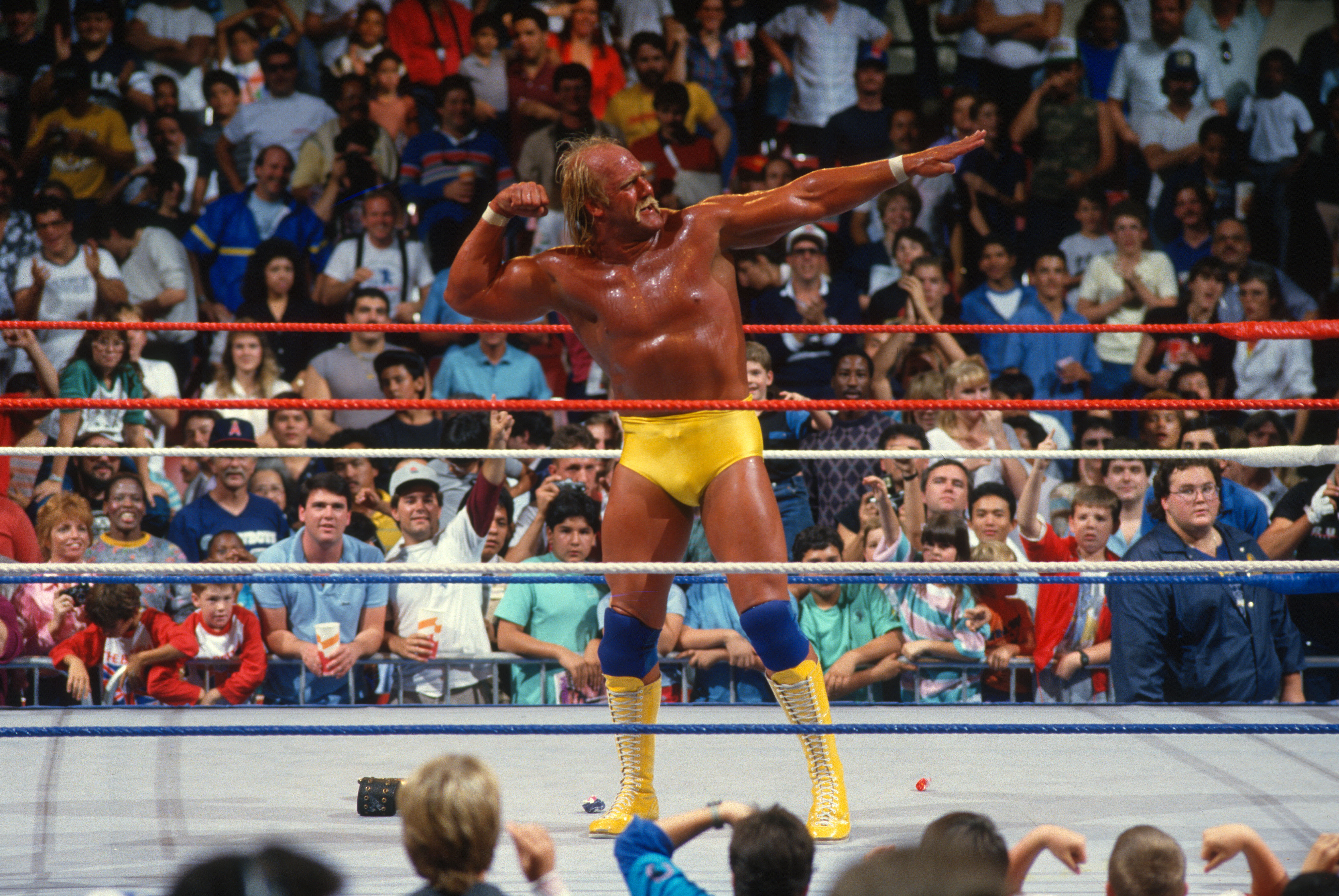 UNSPECIFIED, UNSPECIFIED - CIRCA 1986: Hulk Hogan makes his entrance in circa 1986 at a WWE event. (Photo by WWE/WWE via Getty Images.)