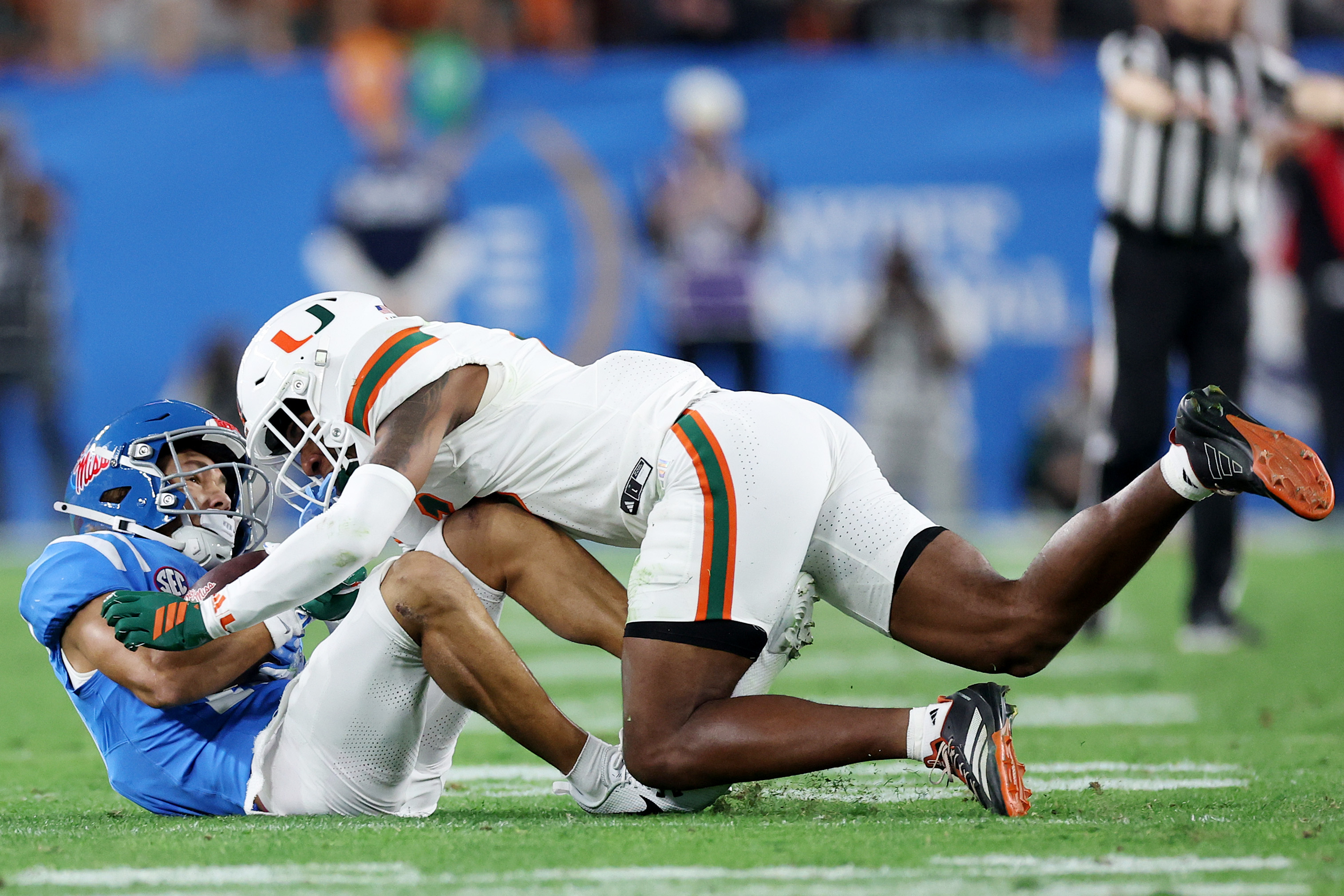 GLENDALE, ARIZONA - JANUARY 08: Xavier Lucas #6 of the Miami Hurricanes tackles Cayden Lee #19 of the Ole Miss Rebels in the fourth quarter during the 2025 College Football Playoff Semifinal at the VRBO Fiesta Bowl at State Farm Stadium on January 08, 2026 in Glendale, Arizona.  (Photo by Chris Coduto/Getty Images)