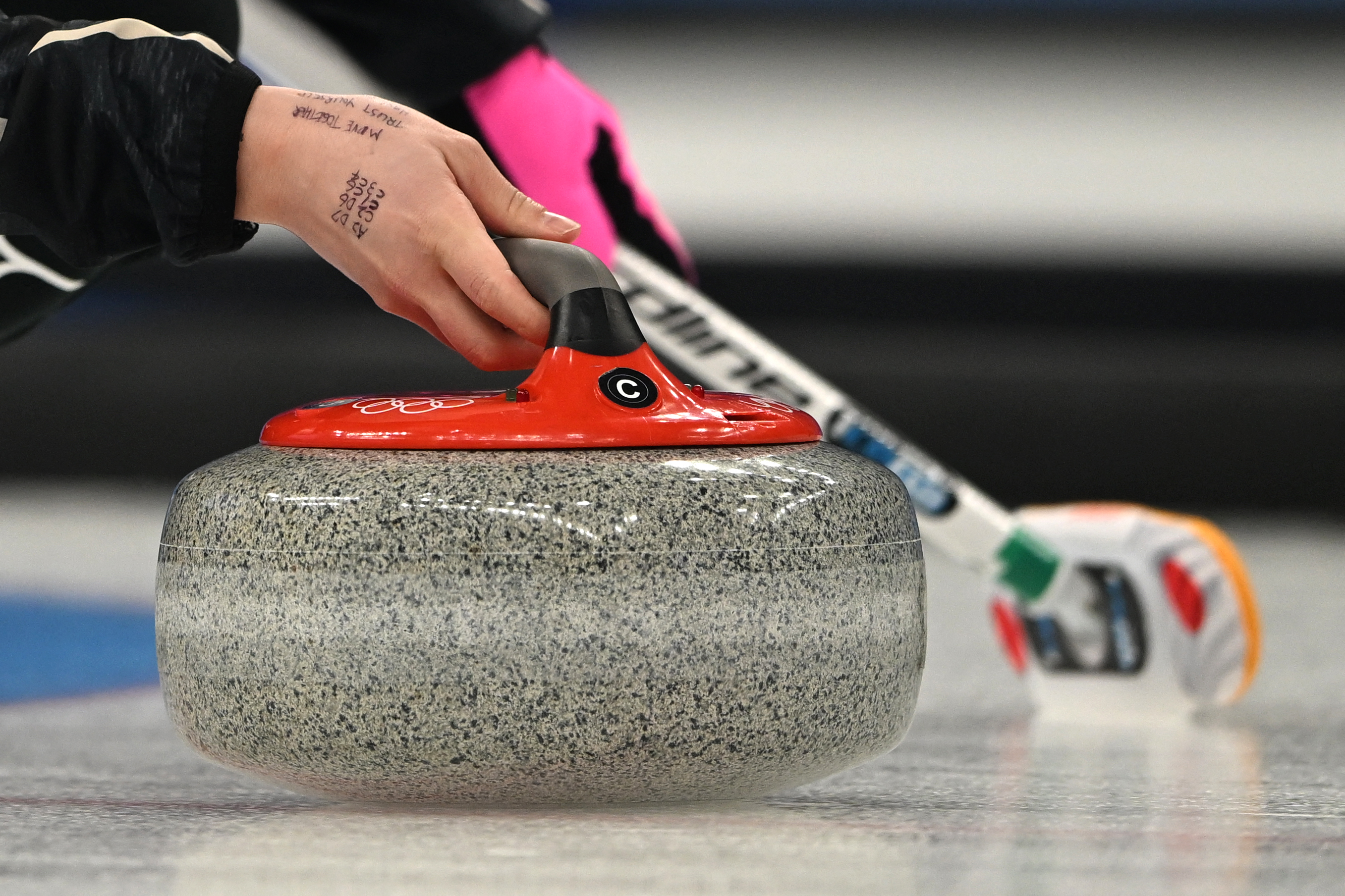 Japan's Satsuki Fujisawa curls the stone during the women's gold medal game of the Beijing 2022 Winter Olympic Games curling competition between Japan and Great Britain at the National Aquatics Centre in Beijing on February 20, 2022. (Photo by Lillian SUWANRUMPHA / AFP via Getty Images)