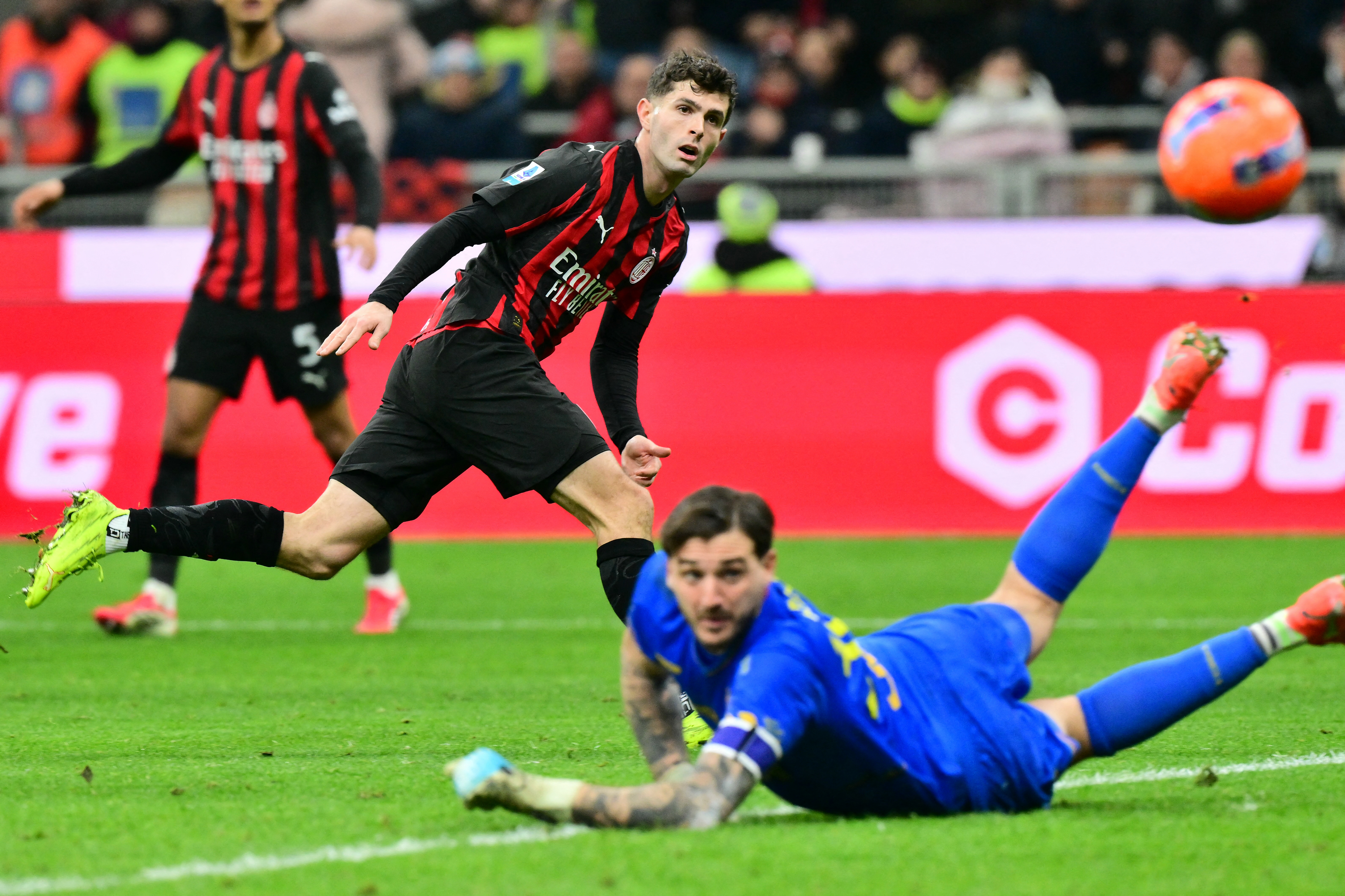 AC Milan's US forward #11 Christian Pulisic tries to score against Lecce's Italian goalkeeper #30 Wladimiro Falcone during the Italian Serie A football match between AC Milan and Lecce at San Siro stadium in Milan, northern Italy, on January 18, 2026. (Photo by Stefano RELLANDINI / AFP via Getty Images)