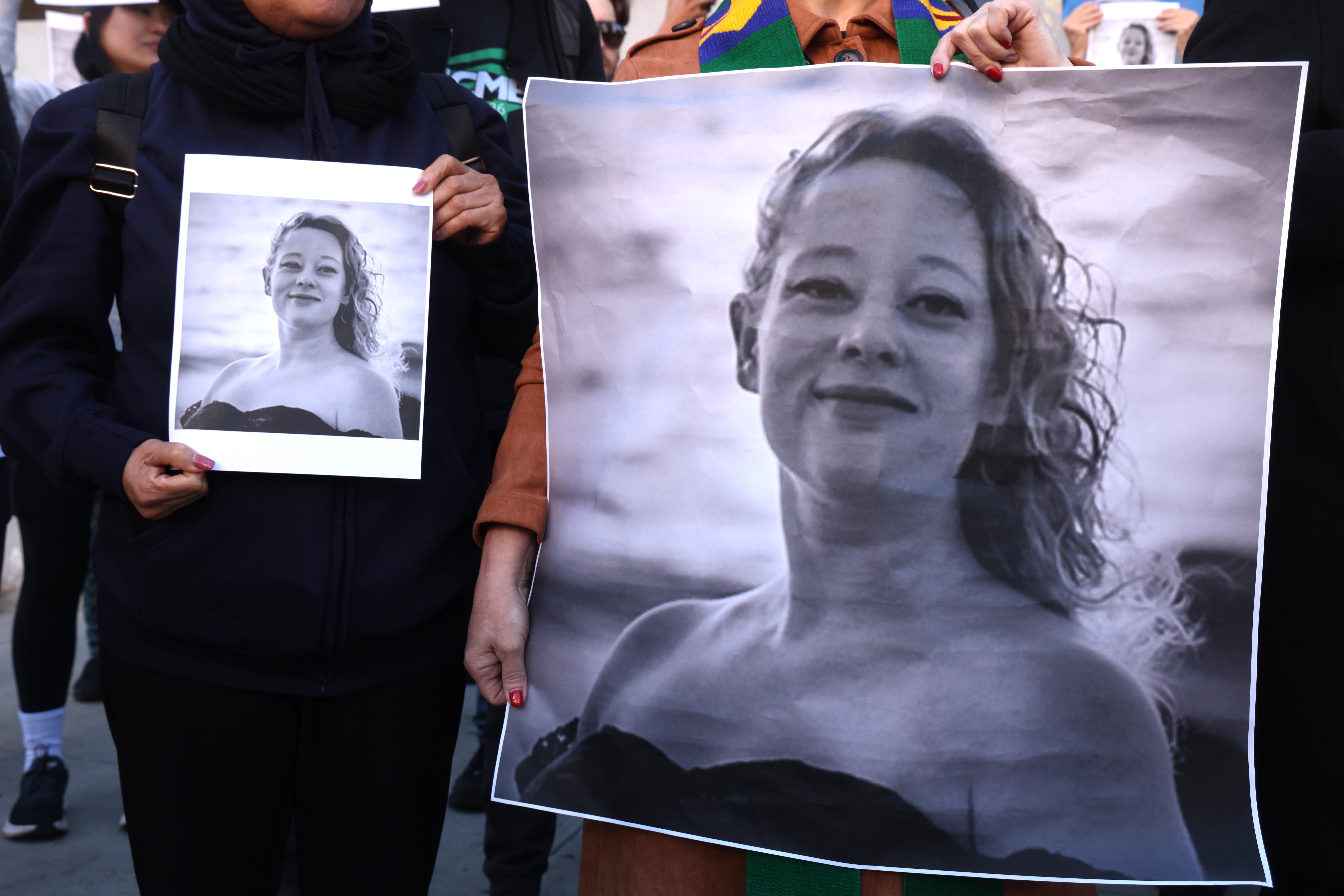 LOS ANGELES,  CA  - JANUARY 8, 2026  Dozens, holding photos of Renee Nicole Good, protest her death a day after an ICE agent killed Good in Minneapolis, in front of the Federal Building in downtown Los Angeles on January 8, 2026. The protest was organized by Clergy and Laity United for Economic Justice (CLUE). (Genaro Molina/Los Angeles Times via Getty Images)