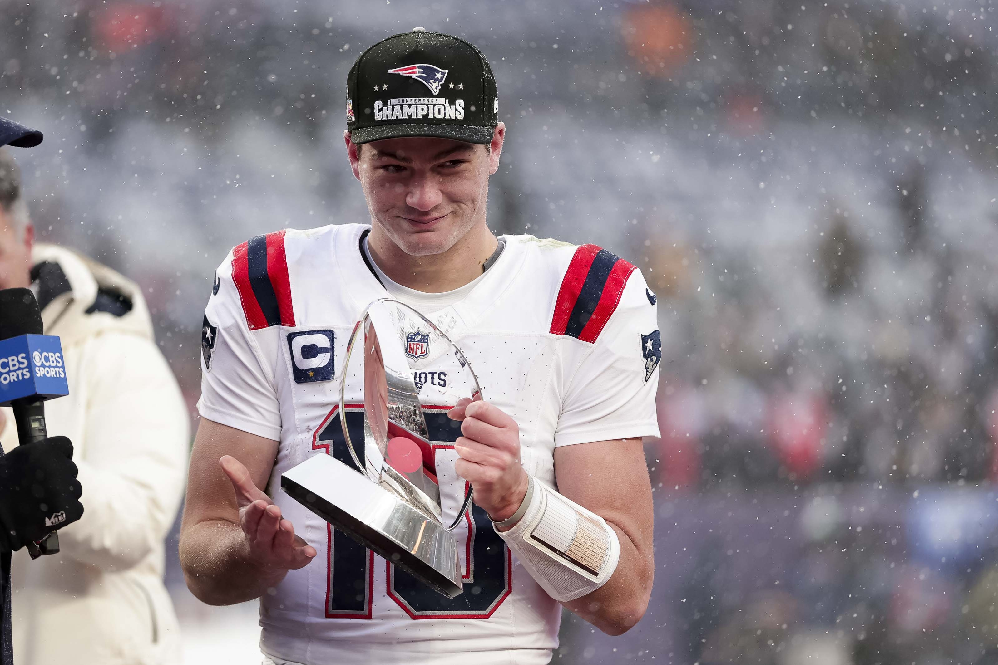 Drake Maye of the New England Patriots celebrates with the Lamar Hunt AFC championship trophy after New England's win over the Broncos. (Photo by Kara Durrette/Getty Images)