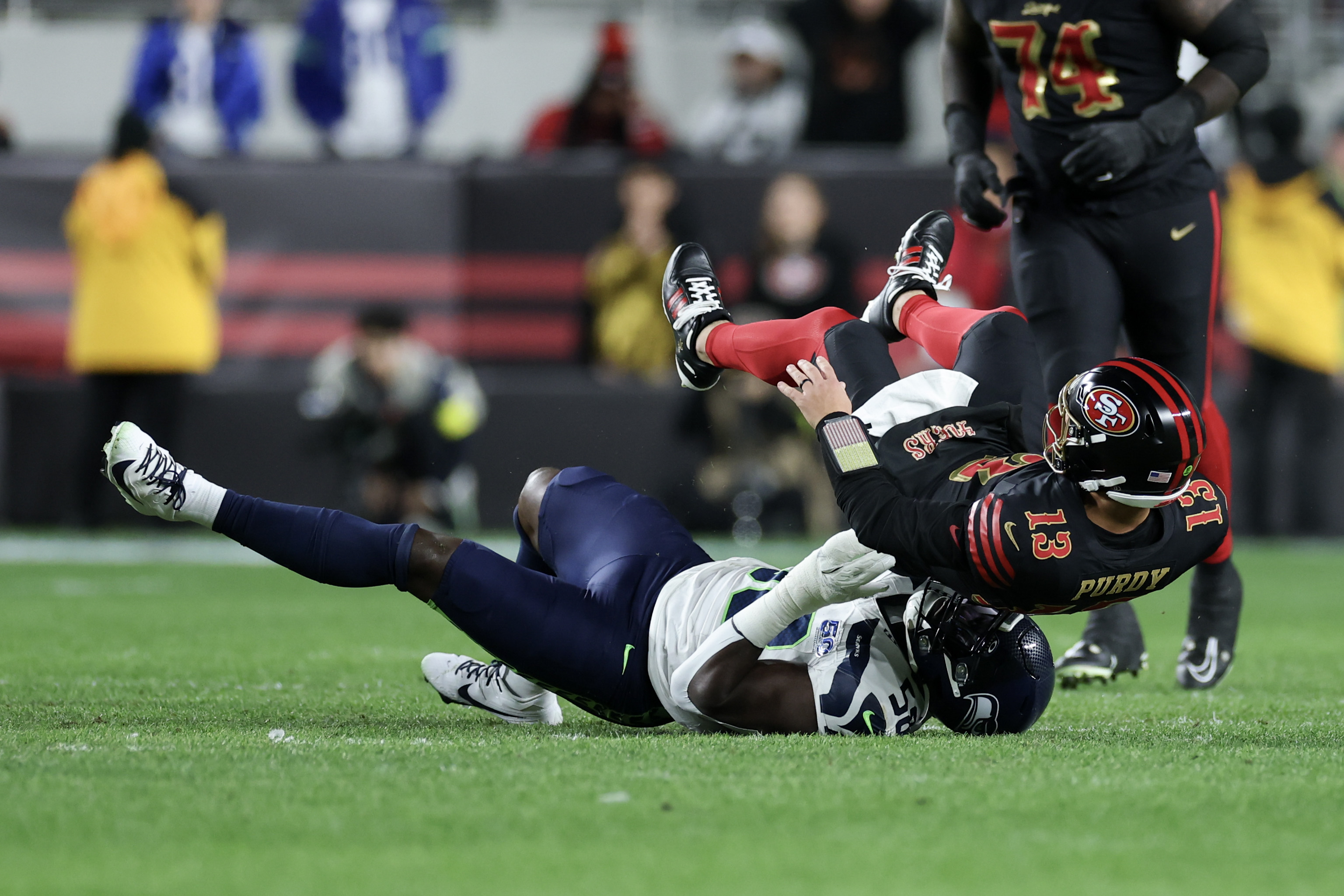 SANTA CLARA, CALIFORNIA - JANUARY 03: Brock Purdy #13 of the San Francisco 49ers is sacked by Derick Hall #58 of the Seattle Seahawks during the first quarter of a gamenat Levi's Stadium on January 03, 2026 in Santa Clara, California. (Photo by Ezra Shaw/Getty Images)