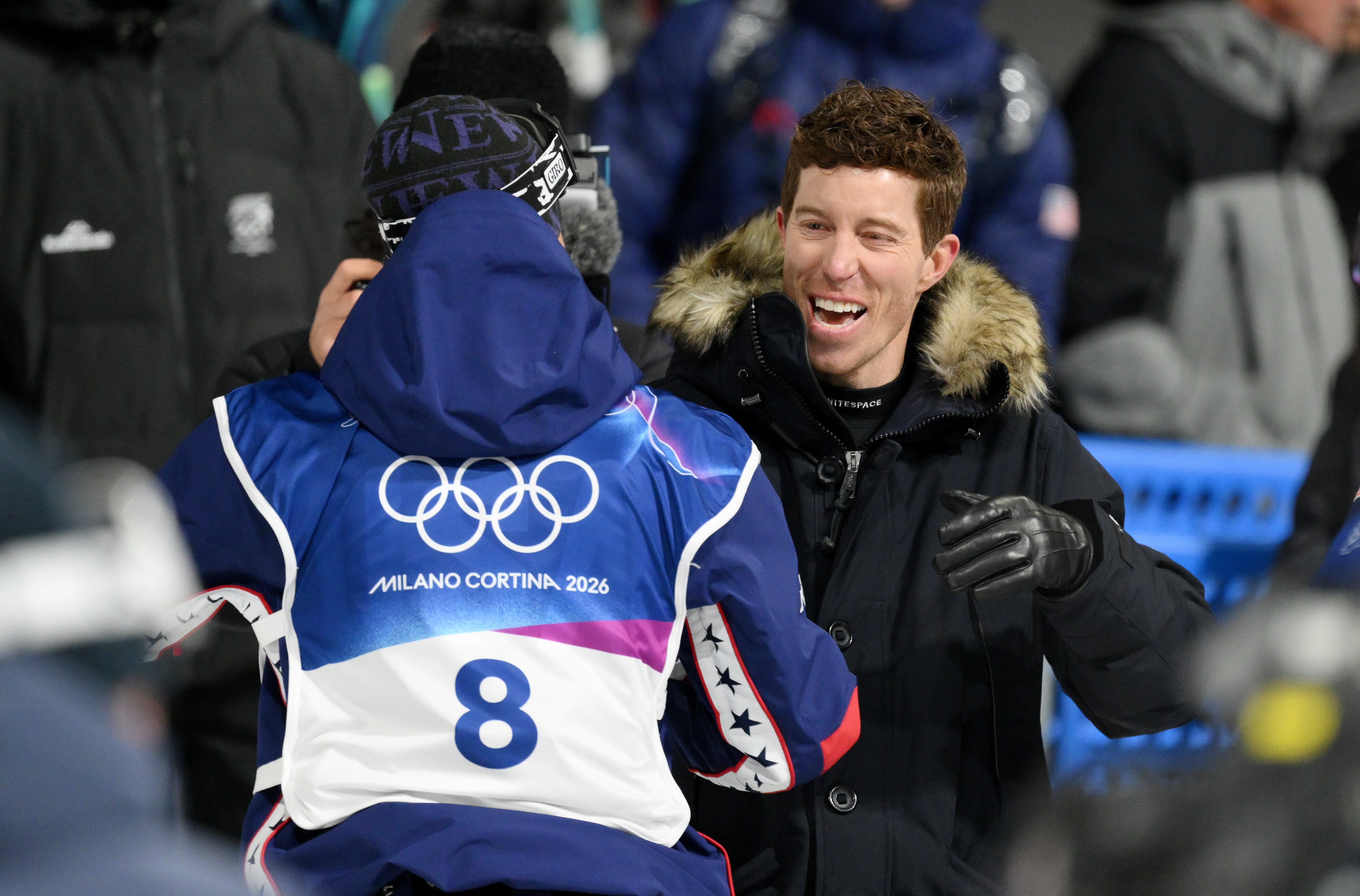 LIVIGNO, ITALY - FEBRUARY 11: Former American snowboarder Shaun White celebrates with Alessandro Barbieri of Team United States during run two of the Men's Snowboard Halfpipe Qualification on day five of the Milano Cortina 2026 Winter Olympic games at Livigno Snow Park on February 11, 2026 in Livigno, Italy. (Photo by David Ramos/Getty Images)