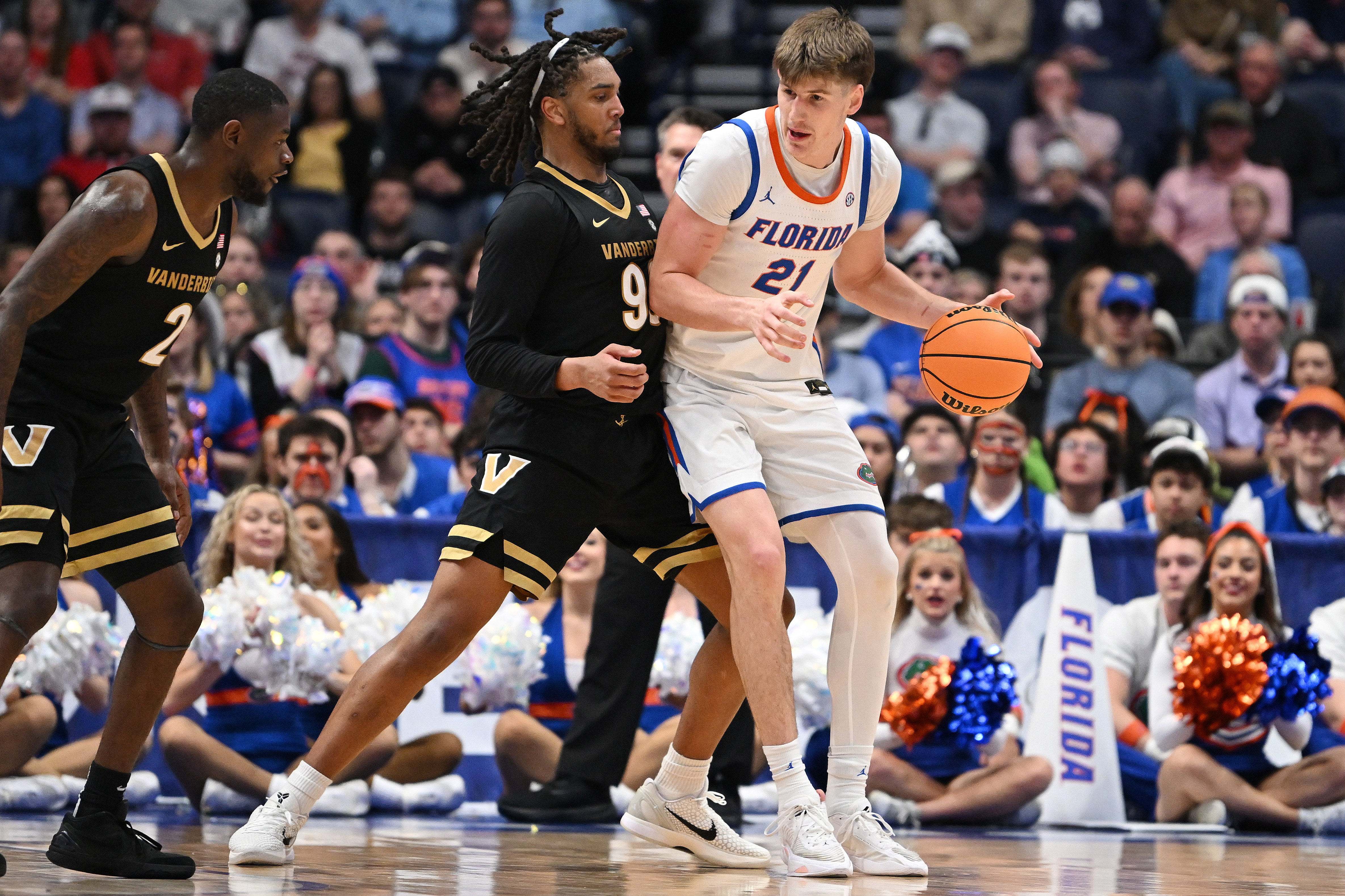 NASHVILLE, TENNESSEE - MARCH 14: Alex Condon #21 of the Florida Gators works against Devin McGlockton #99 of the Vanderbilt Commodores during the second half in the semifinal game of the 2026 SEC Men's Basketball Tournament at Bridgestone Arena on March 14, 2026 in Nashville, Tennessee.  (Photo by Carly Mackler/Getty Images)
