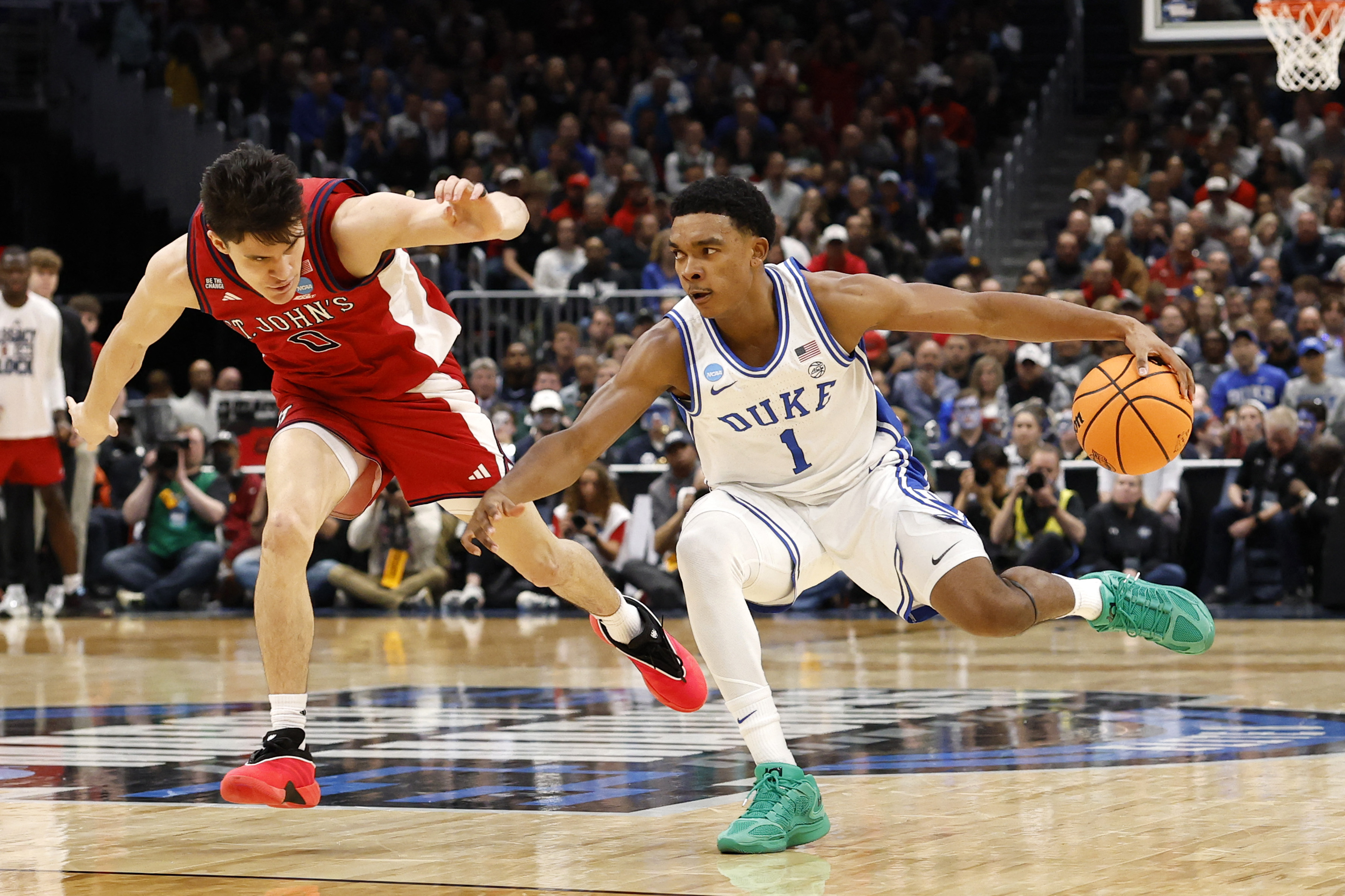 Mar 27, 2026; Washington, DC, USA; Duke Blue Devils guard Caleb Foster (1) dribbles the ball against St. John's Red Storm guard Dylan Darling (0) in the first half during a Sweet Sixteen game of the East Regional of the men's 2026 NCAA Tournament at Capital One Arena. Mandatory Credit: Amber Searls-Imagn Images