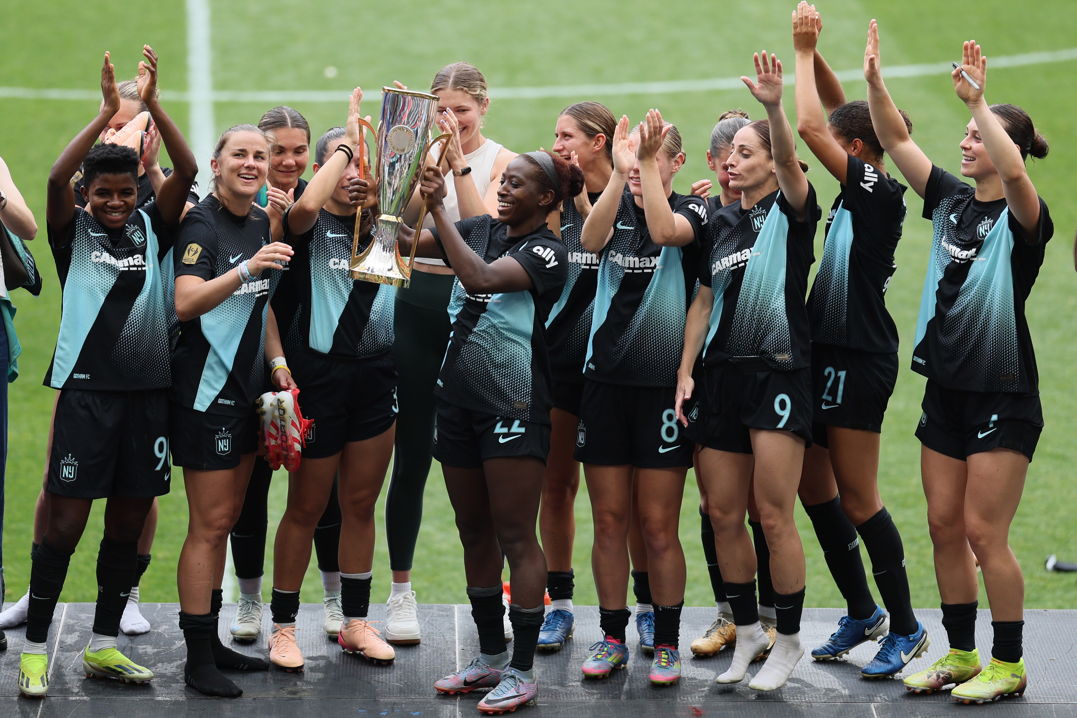 HARRISON, NEW JERSEY - JUNE 07: Mandy Freeman #22 of NJ/NY Gotham FC and teammates celebrate with the Concacaf Champions trophy after the NWSL match between NJ/NY Gotham FC and Kansas City Current at Sports Illustrated Stadium on June 07, 2025 in Harrison, New Jersey. (Photo by Caean Couto/NWSL via Getty Images)