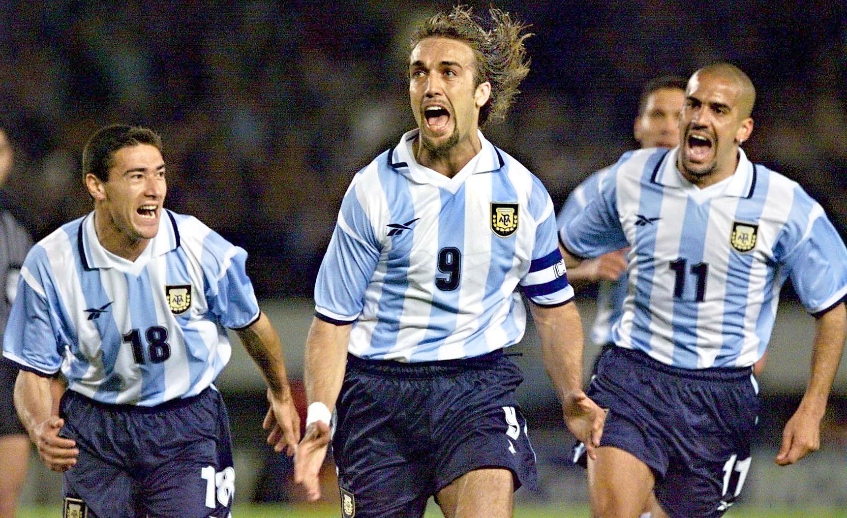 Argentine soccer star Gabriel Batistuta (9) celebrates scoring the first goal against Chile 29 March, 2000, at Monumental Stadium in Buenos Aires in their World Cup 2002 elimination match. Batistuta's teammates Cristian Gonzalez (L) and Sebastian Veron also celebrate.Gabriel Batistuta (C) festeja el primer gol para Argentina flanqueado por Cristian Gonzalez (I) y Sebastian Veron en el estadio Monumental en Buenos Aires, Argentina el 29 de Marzo de 2000. Argentina y Chile se enfrentan por las eliminatorias sudamericanas para la Copa del Mundo Japon-Corea del Sur 2002. (ELECTRONIC IMAGE)   AFP PHOTO / Daniel GARCIA (Photo by DANIEL GARCIA / AFP) (Photo by DANIEL GARCIA/AFP via Getty Images)