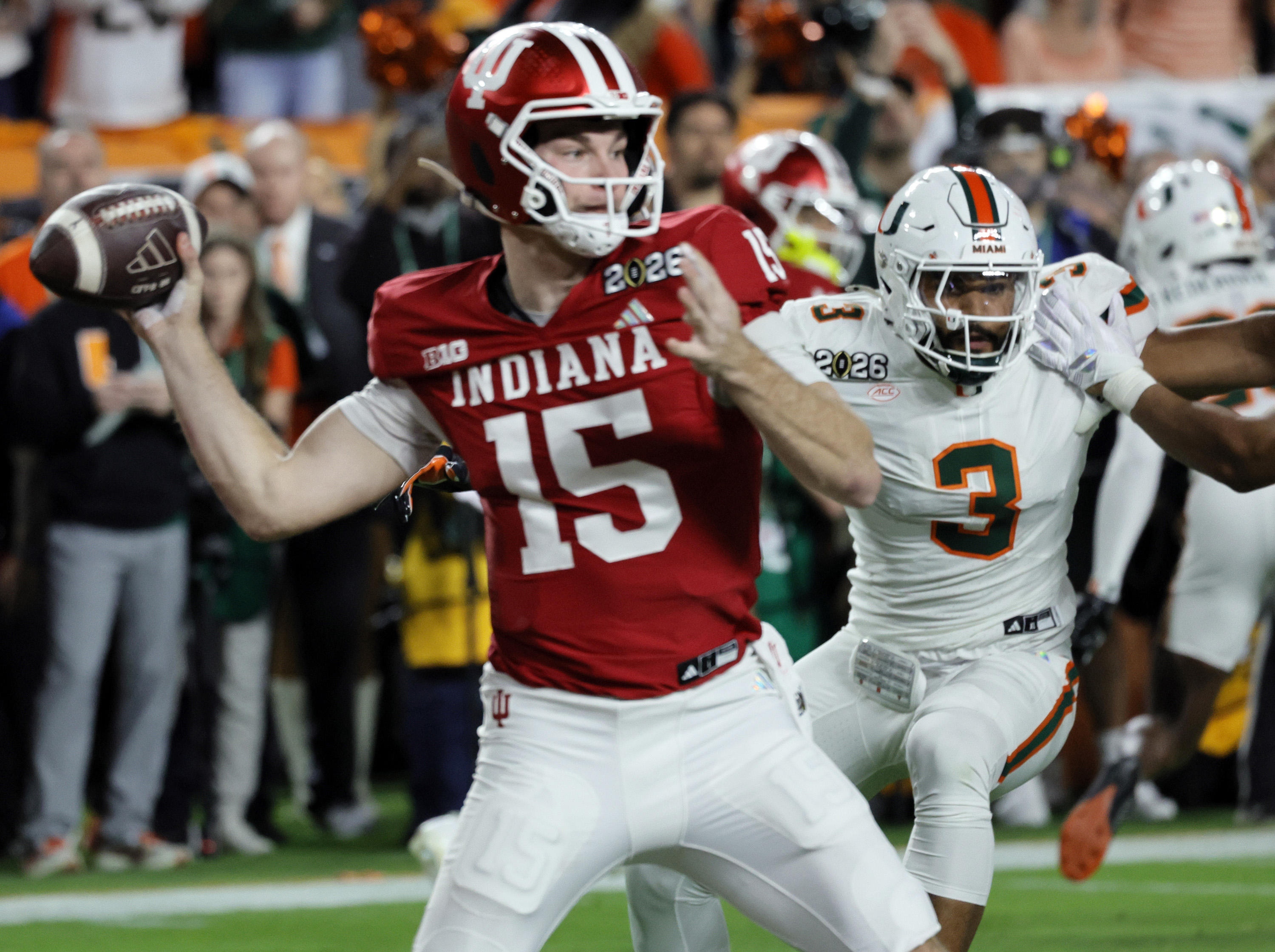 Indiana Hoosiers quarterback Fernando Mendoza (15) is pressured by Miami Hurricanes defensive lineman Akheem Mesidor (3), Monday, Jan. 19, 2026, during the National Championship game at Hard Rock Stadium in Miami Gardens, Florida. (Joe Cavaretta/South Florida Sun Sentinel/Tribune News Service via Getty Images)