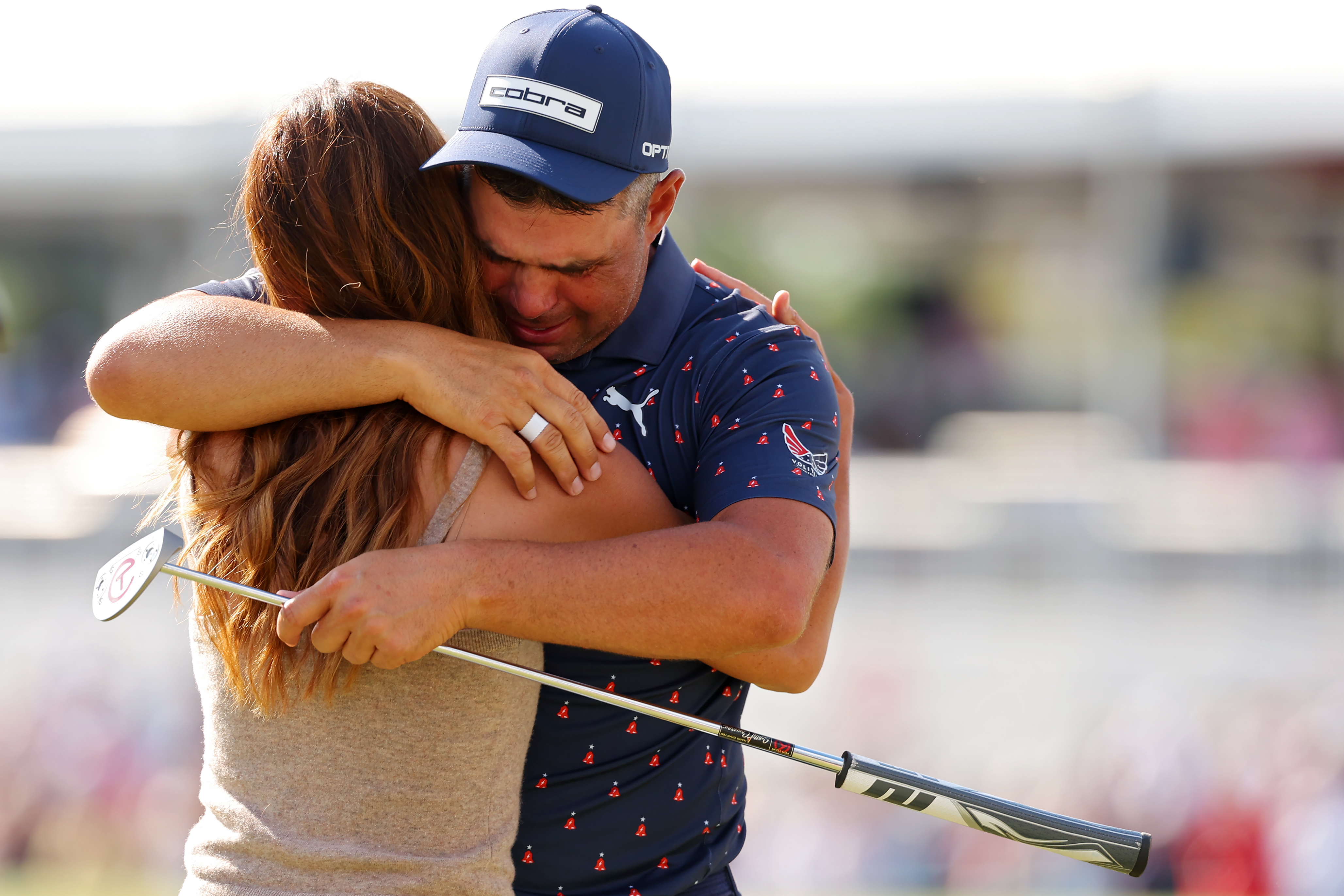 HOUSTON, TEXAS - MARCH 29: Gary Woodland of the United States embraces wife Gabby Granado on the 18th green after winning the Texas Children's Houston Open 2026 at Memorial Park Golf Course on March 29, 2026 in Houston, Texas. (Photo by Jordan Bank/Getty Images)