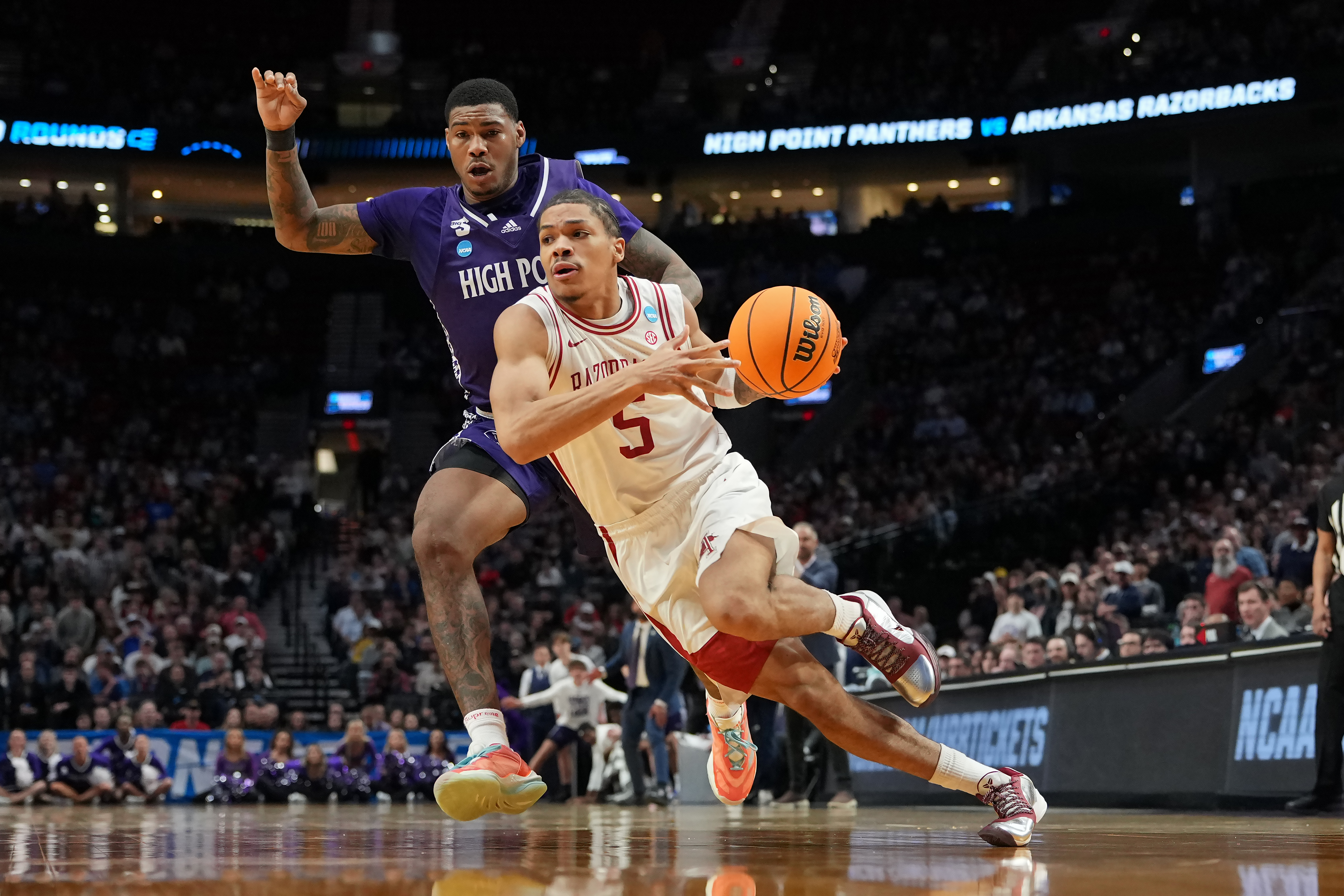 PORTLAND, OREGON - MARCH 21: Darius Acuff Jr. #5 of the Arkansas Razorbacks dribbles the ball while being guarded by Cam'Ron Fletcher #11 of the High Point Panthers during the second half in the second round of the 2026 NCAA Men's Basketball Tournament at Moda Center on March 21, 2026 in Portland, Oregon.  (Photo by Soobum Im/Getty Images)