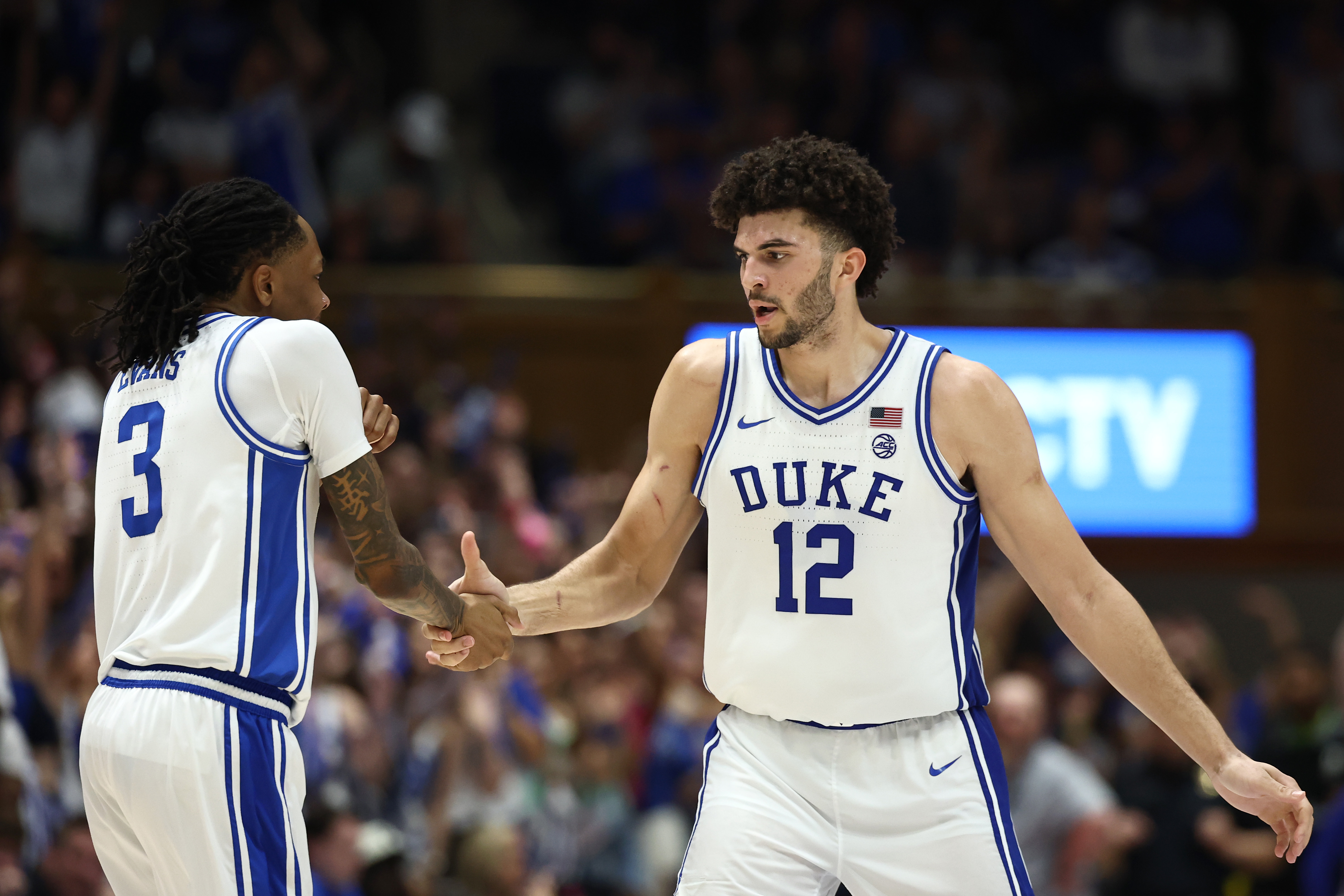 DURHAM, NORTH CAROLINA - MARCH 07: Cameron Boozer #12 and Isaiah Evans #3 of the Duke Blue Devils react during the second half of the game against the North Carolina Tar Heelsat Cameron Indoor Stadium on March 07, 2026 in Durham, North Carolina. (Photo by Jared C. Tilton/Getty Images)