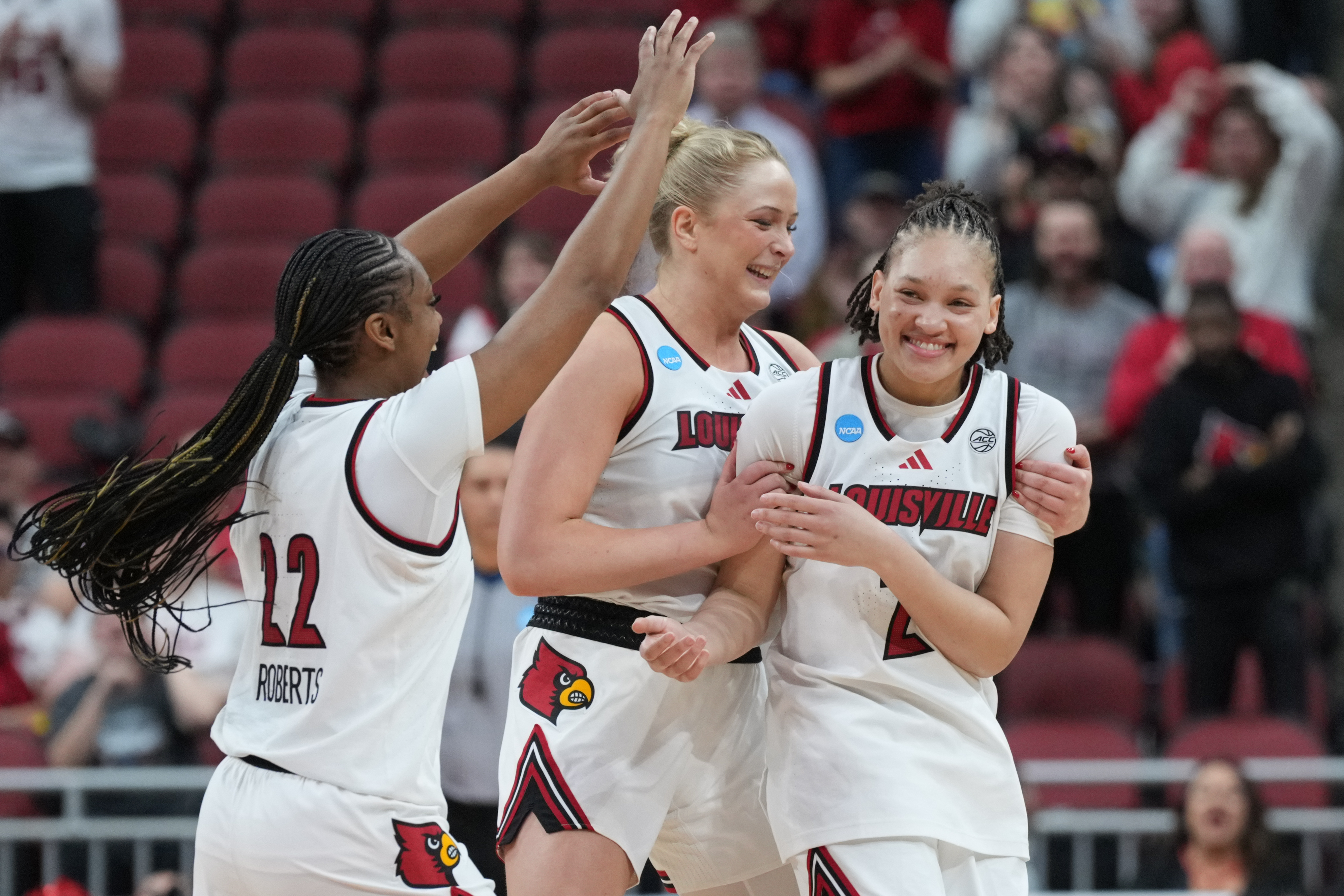 LOUISVILLE, KENTUCKY - MARCH 23: Imari Berry #2 of the Louisville Cardinals is congratulated by teammates Tajianna Roberts #22 of the Louisville Cardinals and Laura Ziegler #0 of the Louisville Cardinals during the fourth quarter of a second round game of the 2026 NCAA Women's Basketball Tournament held at KFC YUM! Center on March 23, 2026 in Louisville, Kentucky. (Photo by Grace Bradley/NCAA Photos via Getty Images)