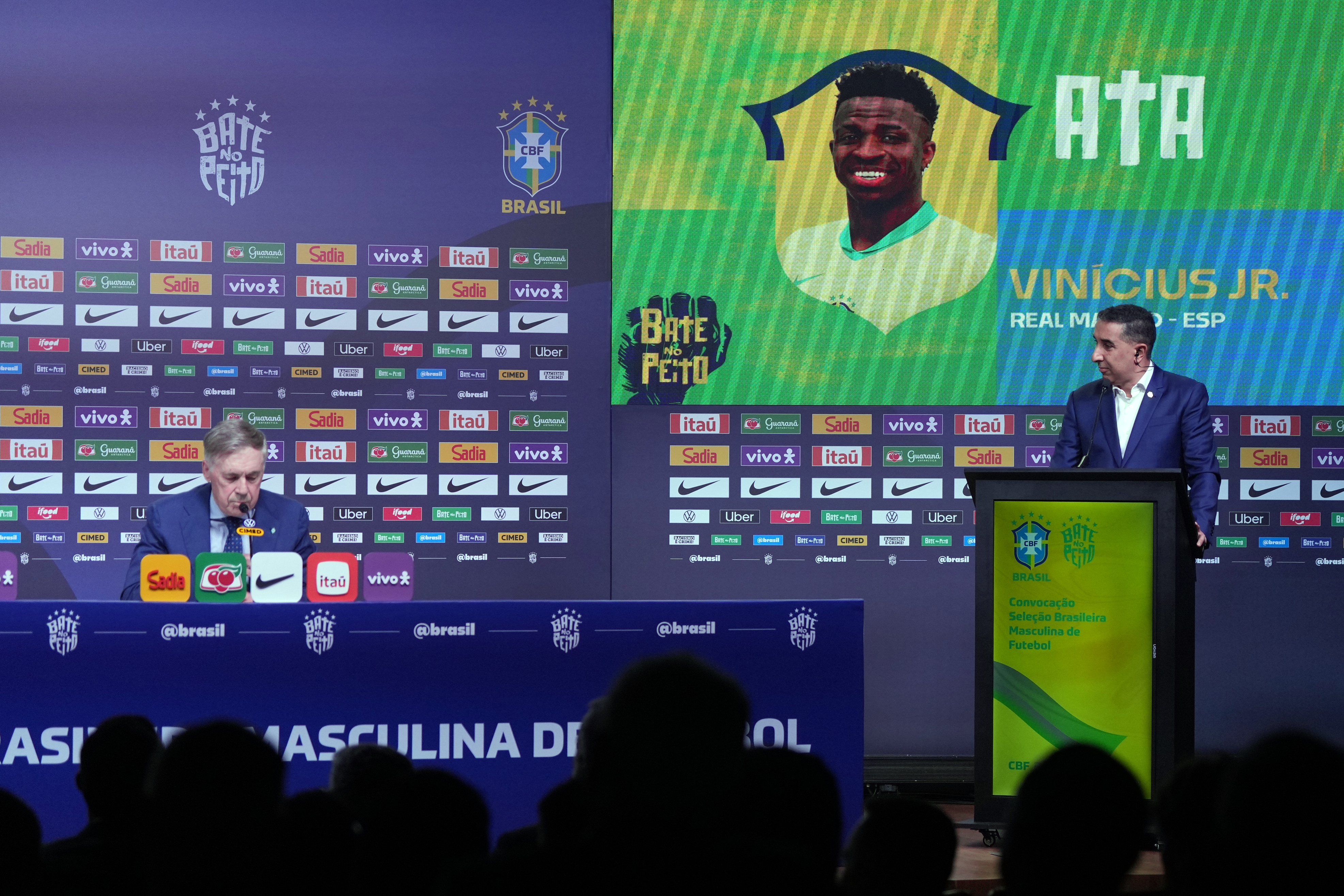 Brazil's national soccer team head coach Carlo Ancelotti, left, announces Vinicius Jr. among the players selected for upcoming friendly matches against France and Croatia in preparation for the upcoming World Cup, in Rio de Janeiro, Monday, March 16, 2026. (AP Photo/Silvia Izquierdo)
