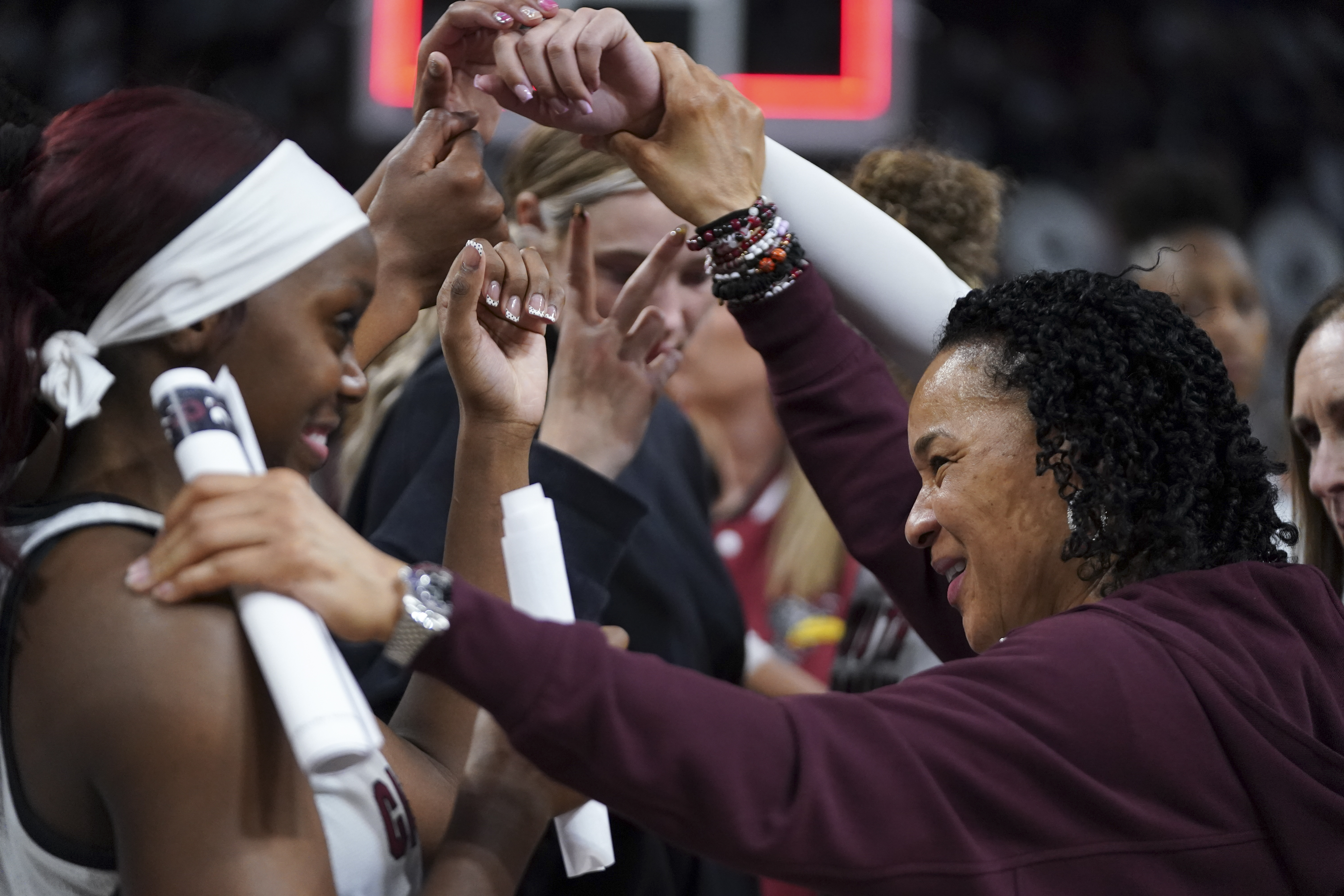 COLUMBIA, SOUTH CAROLINA - FEBRUARY 22: Head coach Dawn Staley of the South Carolina Gamecocks , right, and guard Raven Johnson huddle with the team after an NCAA women's basketball game against the Ole Miss Rebels at Colonial Life Arena on February 22, 2026 in Columbia, South Carolina. (Photo by Sean Rayford/Getty Images)
