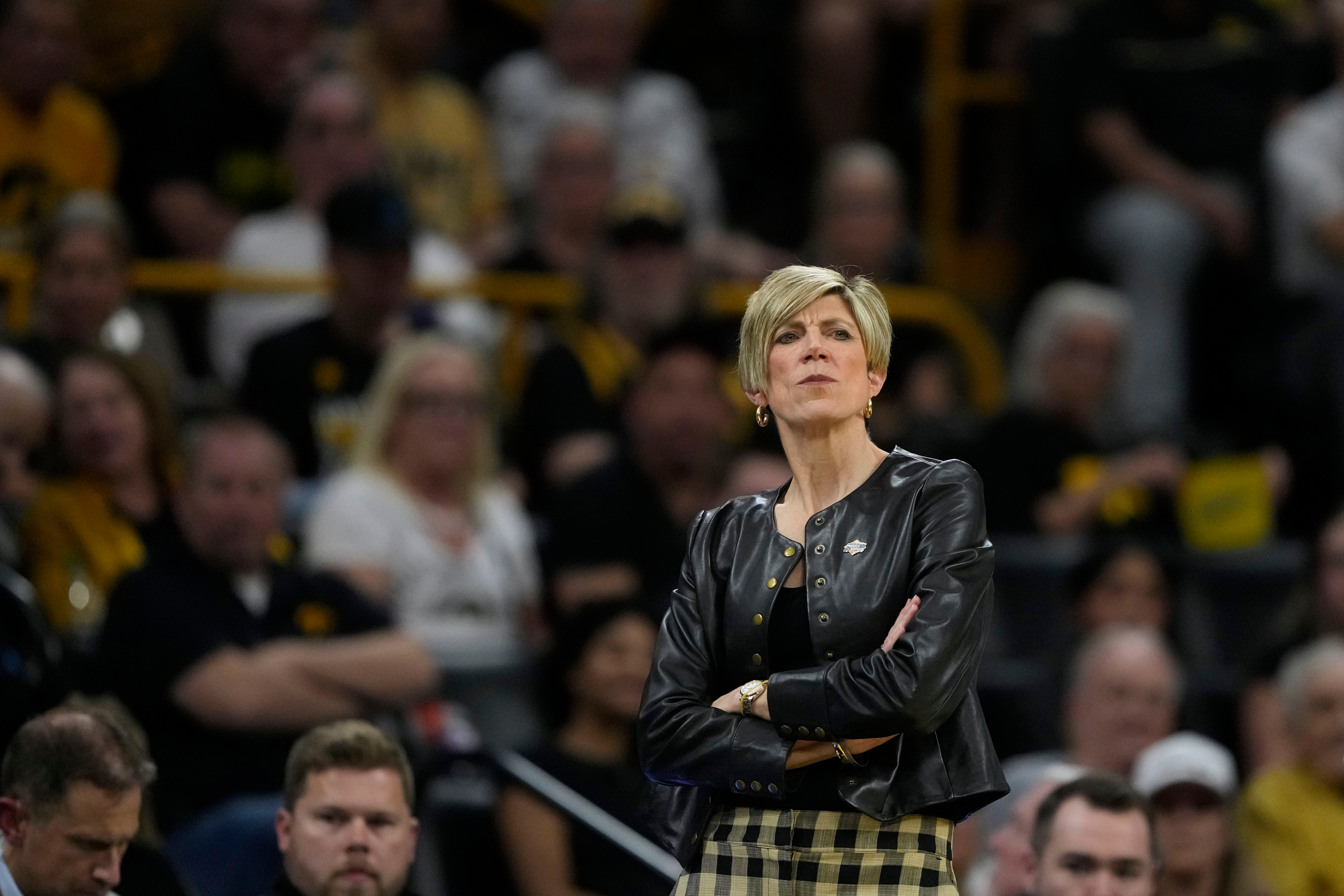 Iowa head coach Jan Jensen watches from the bench during the first half against Fairleigh Dickinson in the first round of the NCAA college basketball tournament, Saturday, March 21, 2026, in Iowa City, Iowa. (AP Photo/Charlie Neibergall)