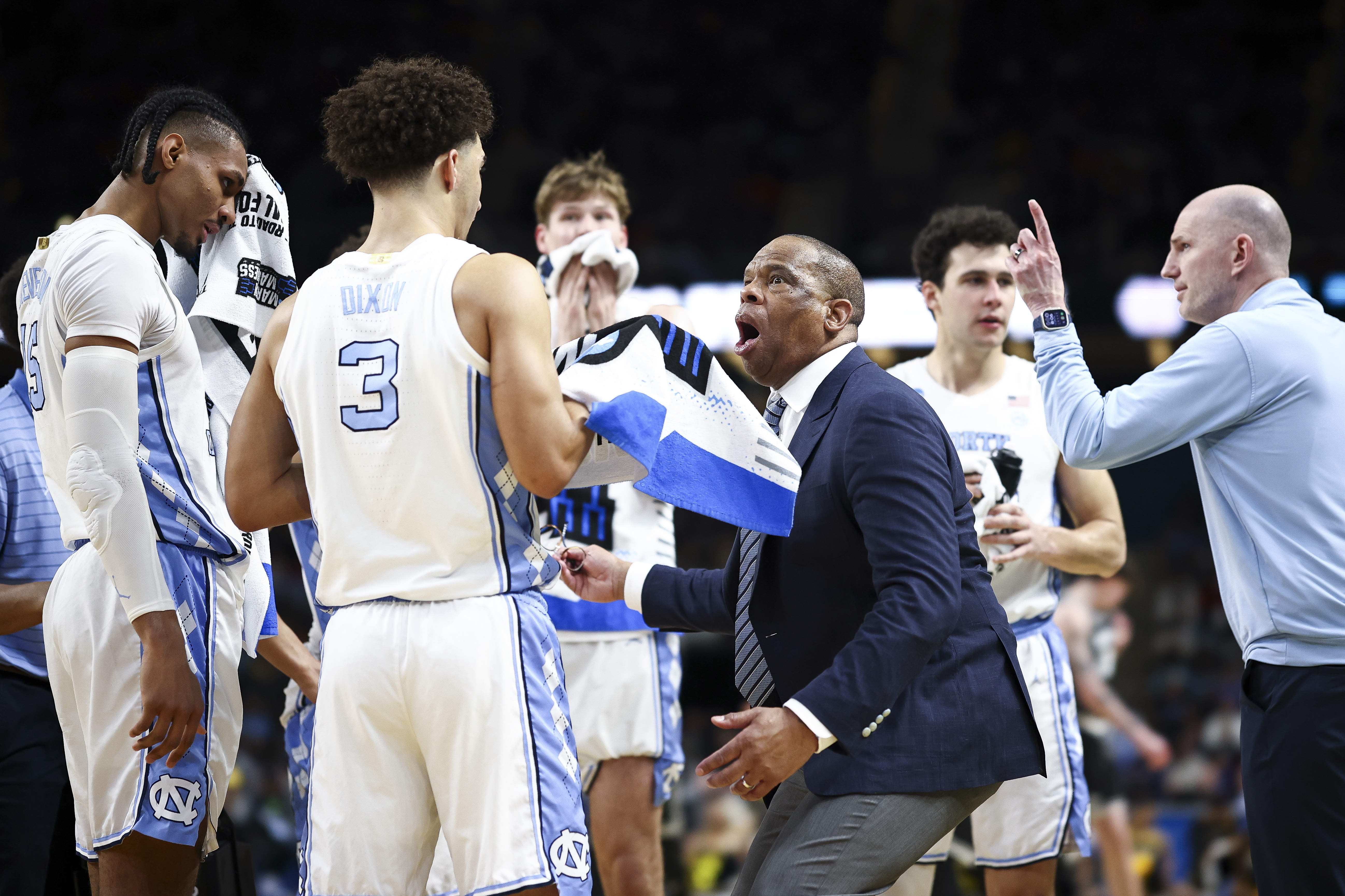 GREENVILLE, SOUTH CAROLINA - MARCH 19: Head coach Hubert Davis of the North Carolina Tar Heels reacts with Derek Dixon #3 during a timeout in the second half against the VCU Rams in the first round of the 2026 NCAA Men's Basketball Tournament at Bon Secours Wellness Arena on March 19, 2026 in Greenville, South Carolina. (Photo by Jared C. Tilton/Getty Images)