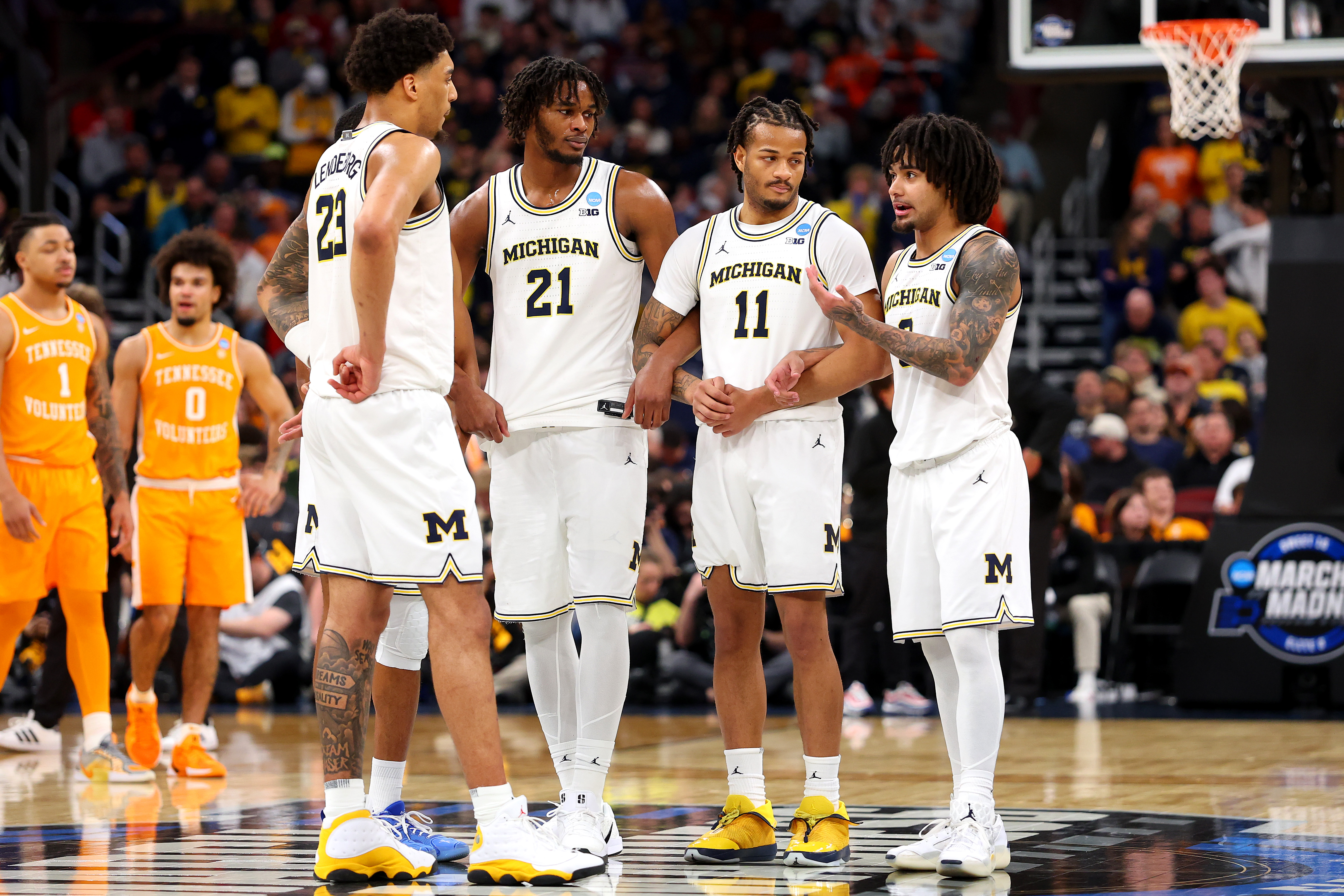 CHICAGO, ILLINOIS - MARCH 29: Yaxel Lendeborg #23, Morez Johnson Jr. #21, Roddy Gayle Jr. #11, and Elliot Cadeau #3 of the Michigan Wolverines embrace against the Tennessee Volunteers during the second half in the Elite Eight of the 2026 NCAA Men's Basketball Tournament at the United Center on March 29, 2026 in Chicago, Illinois.  (Photo by Gregory Shamus/Getty Images)
