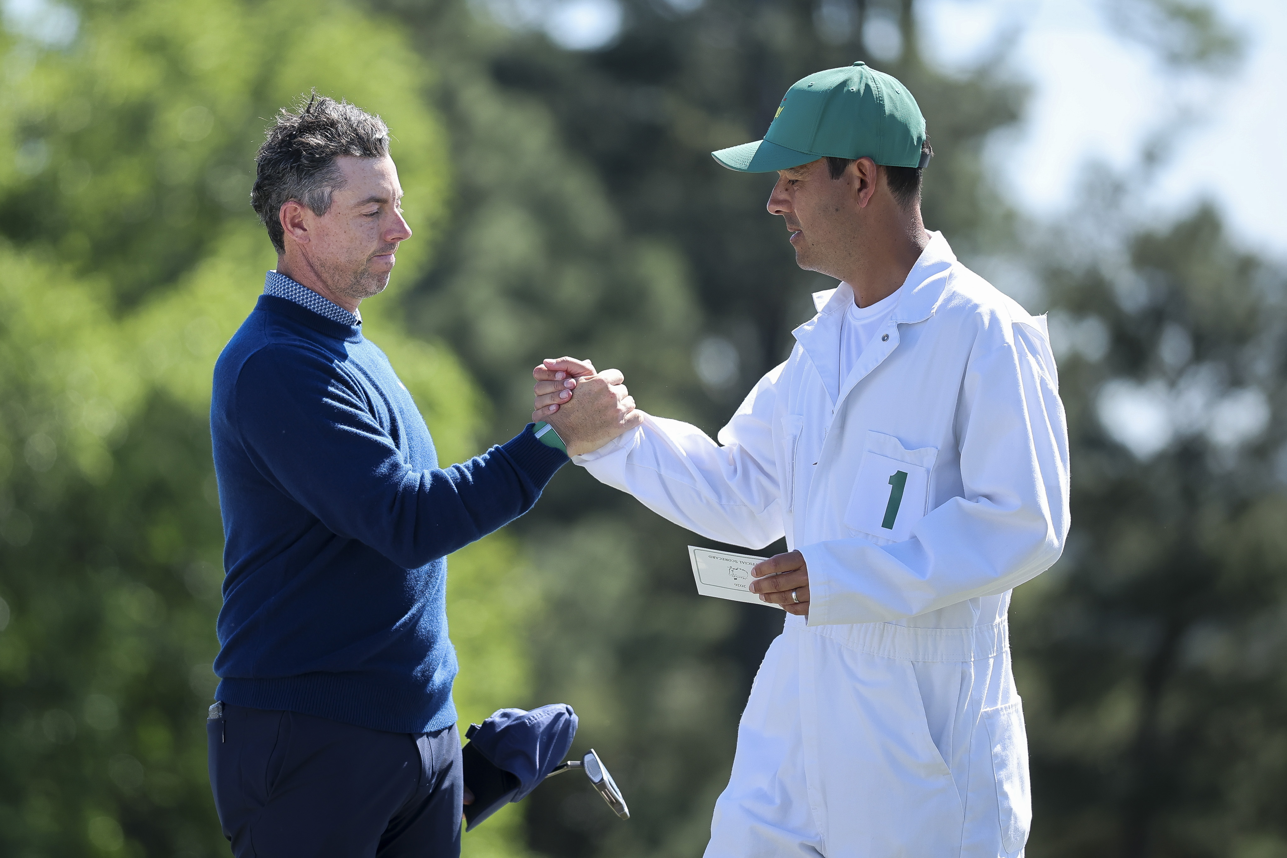 AUGUSTA, GEORGIA - APRIL 09: Rory McIlroy of Northern Ireland and his caddie Harry Diamond shake hands on the 18th green during the first round of the 2026 Masters Tournament at Augusta National Golf Club on April 09, 2026 in Augusta, Georgia. (Photo by Hector Vivas/Getty Images)