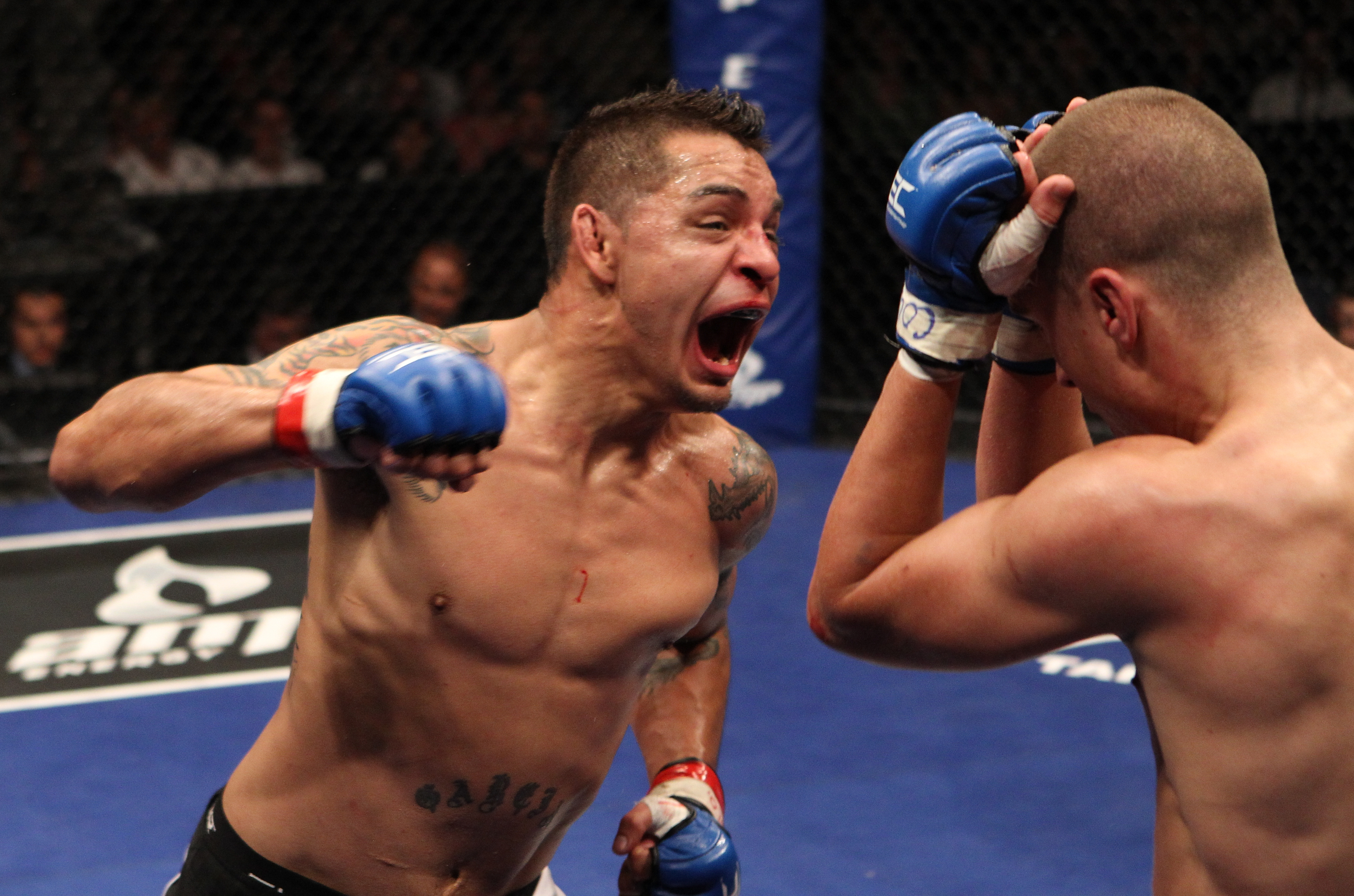 BROOMFIELD, CO - SEPTEMBER 30:  (L-R) Leonard "Bad Boy" Garcia punches Mark Hominick at WEC 51 at the 1stBank Center on September 30, 2010 in Broomfield, Colorado.  (Photo by Josh Hedges/Zuffa LLC/Zuffa LLC via Getty Images)