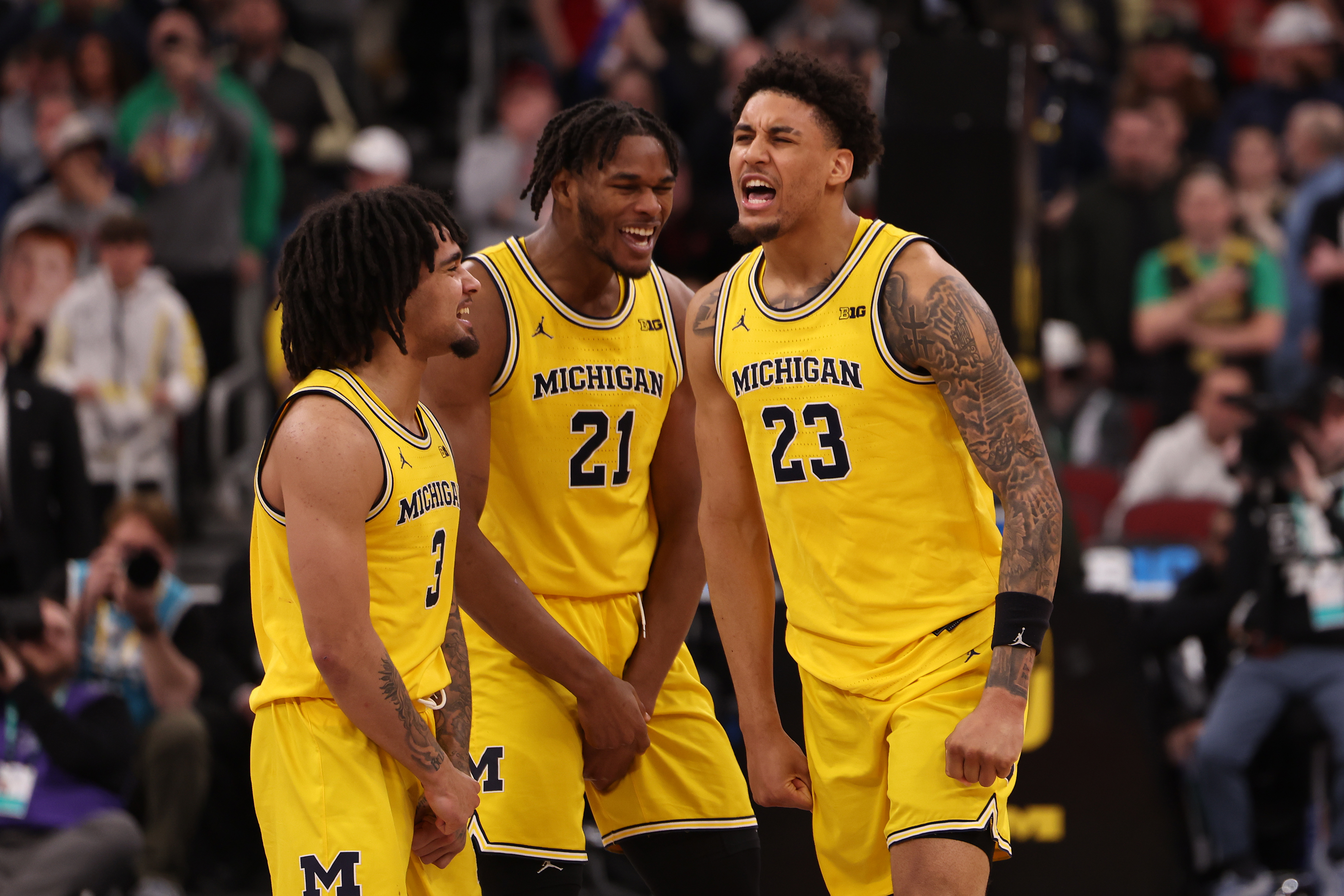 CHICAGO, ILLINOIS - MARCH 14: Yaxel Lendeborg #23 of the Michigan Wolverines celebrates his game-winning three-pointer with teammates Elliot Cadeau #3 and Morez Johnson Jr. #21 against the Wisconsin Badgers during the semifinals of the 2026 Big Ten Men's Basketball Tournament at the United Center on March 14, 2026 in Chicago, Illinois. (Photo by Geoff Stellfox/Getty Images)