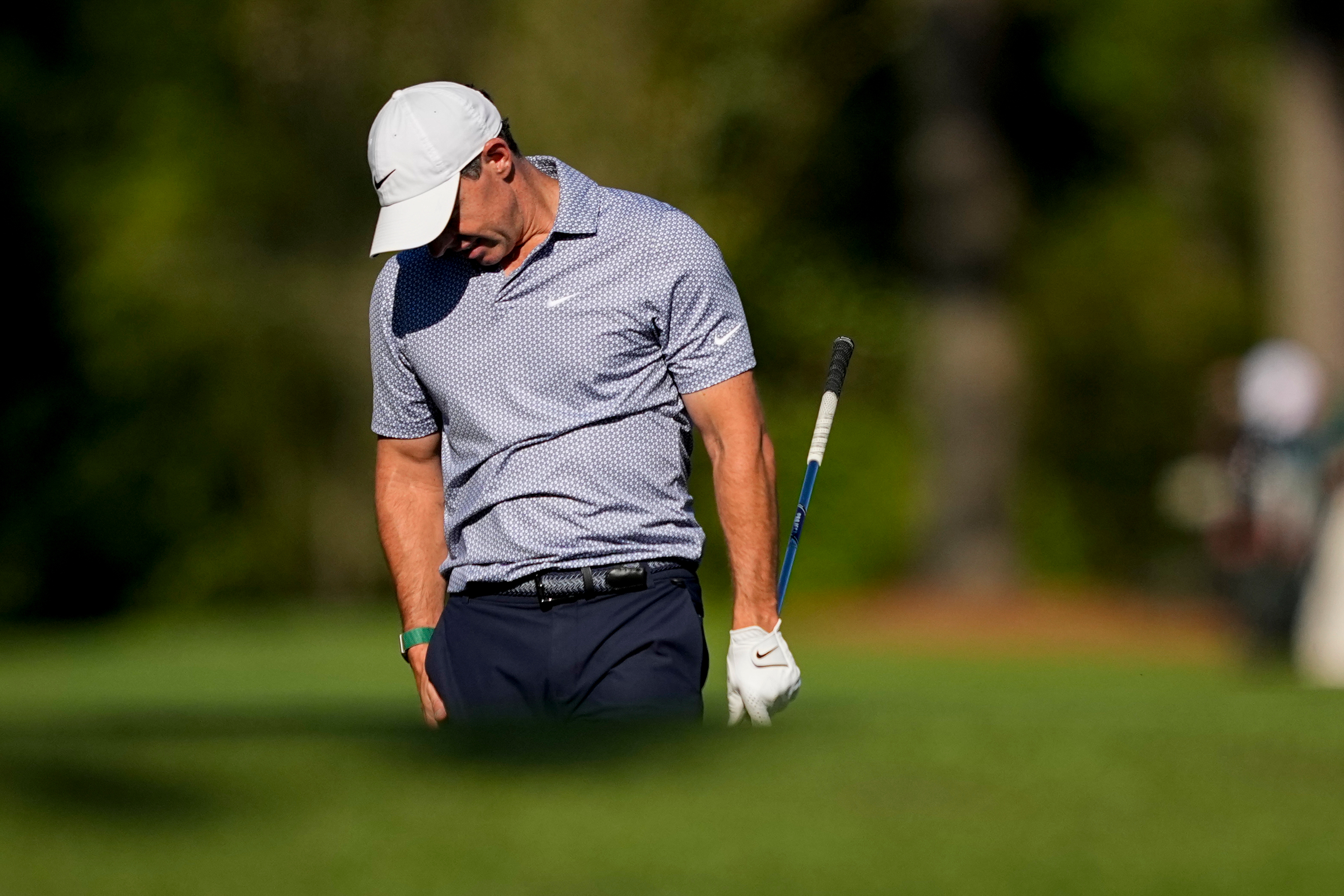 Rory McIlroy, of Northern Ireland, reacts after a tee shot on the 12th hole during the third round of the Masters golf tournament at the Augusta National Golf Club, Saturday, April 11, 2026, in Augusta, Ga. (AP Photo/Gerald Herbert)