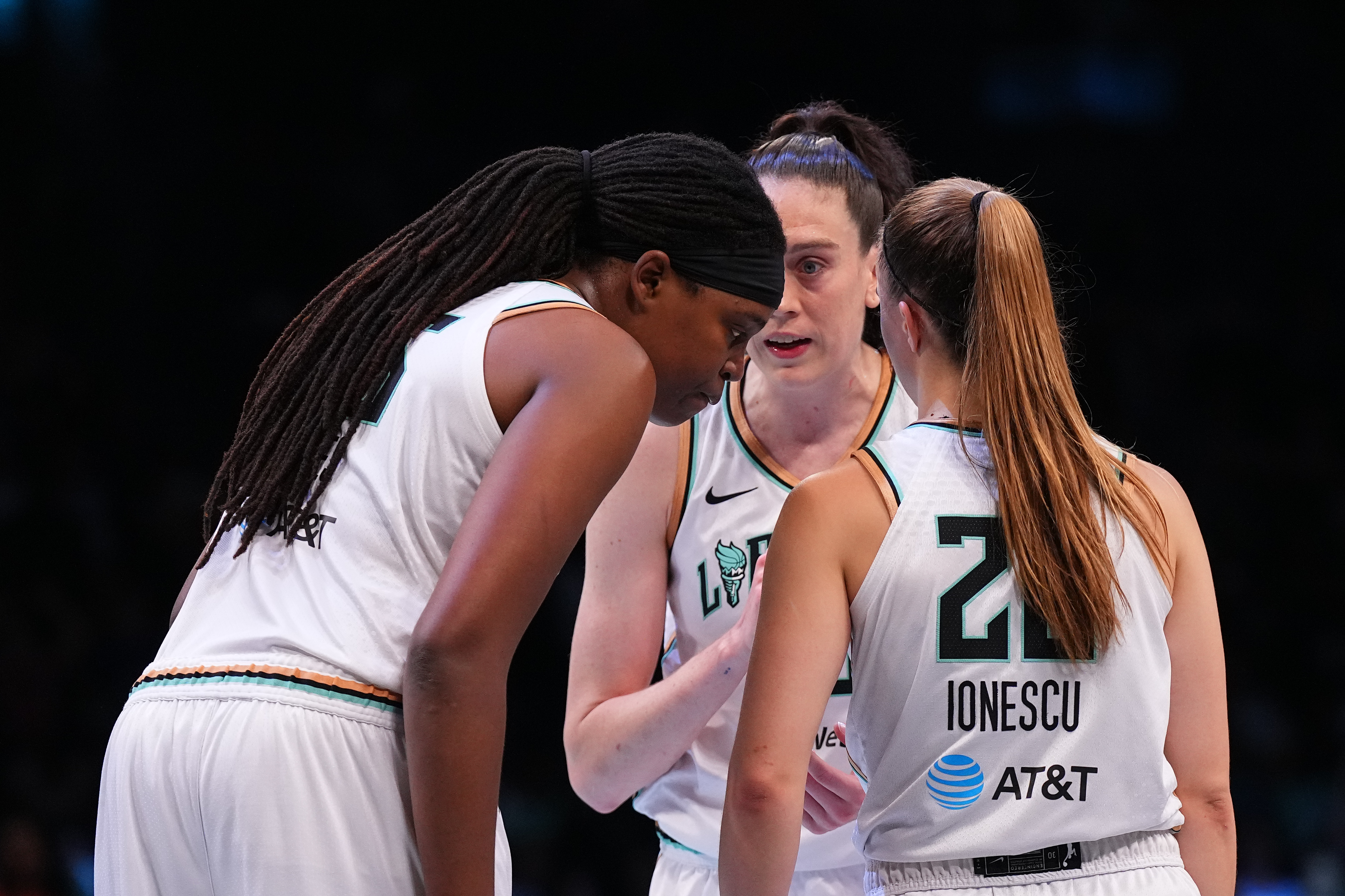 NEW YORK, NEW YORK - JULY 25: Jonquel Jones #35, Breanna Stewart #30, and Sabrina Ionescu #20 of the New York Liberty huddle against the Seattle Storm at the Barclays Center on July 25, 2023 in the Brooklyn borough of New York City. The Liberty defeated the Storm 86-82. NOTE TO USER: User expressly acknowledges and agrees that, by downloading and or using this photograph, User is consenting to the terms and conditions of the Getty Images License Agreement. (Photo by Mitchell Leff/Getty Images)