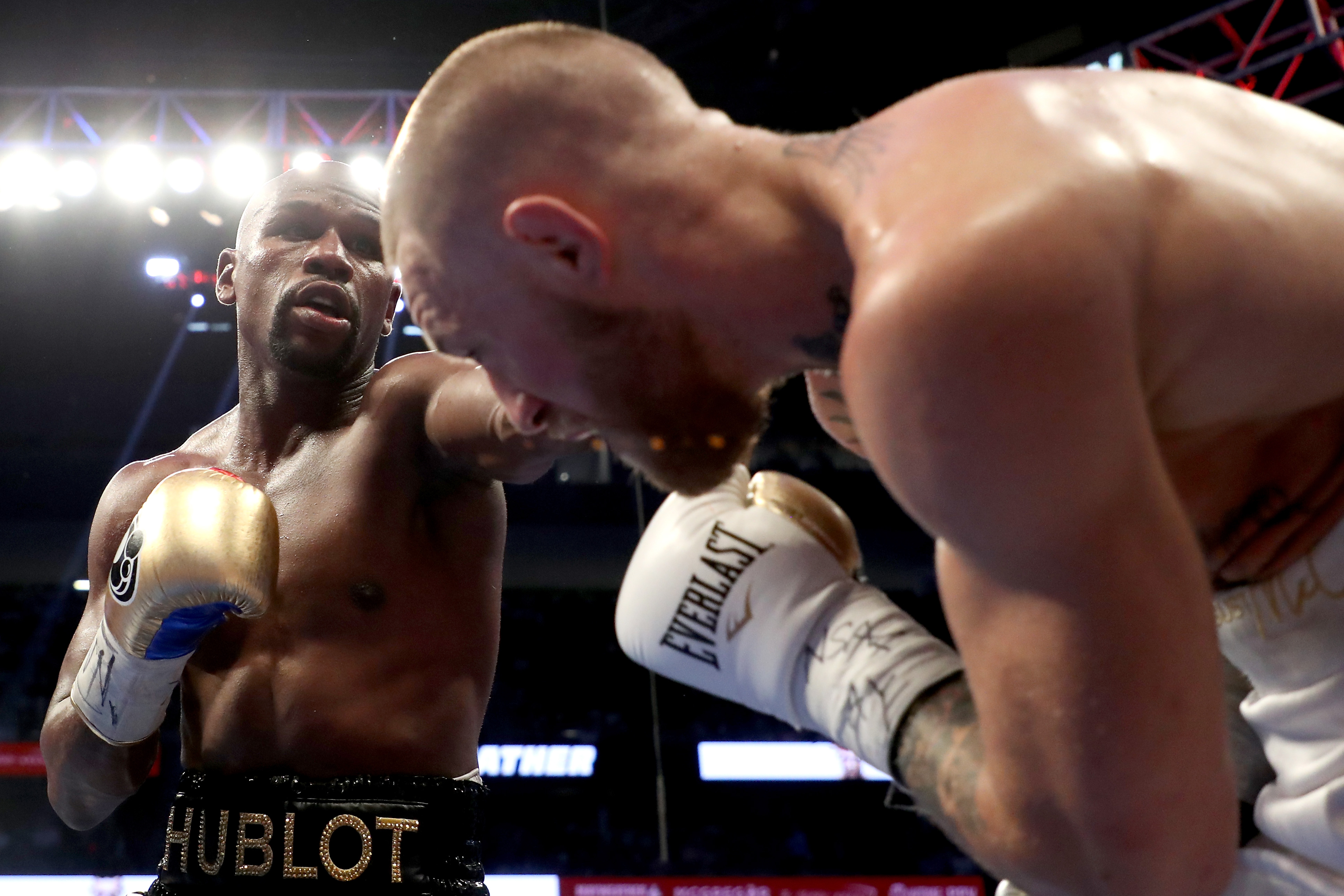 LAS VEGAS, NV - AUGUST 26:  (L-R) Floyd Mayweather Jr. throws a punch at Conor McGregor during their super welterweight boxing match on August 26, 2017 at T-Mobile Arena in Las Vegas, Nevada.  (Photo by Christian Petersen/Getty Images)