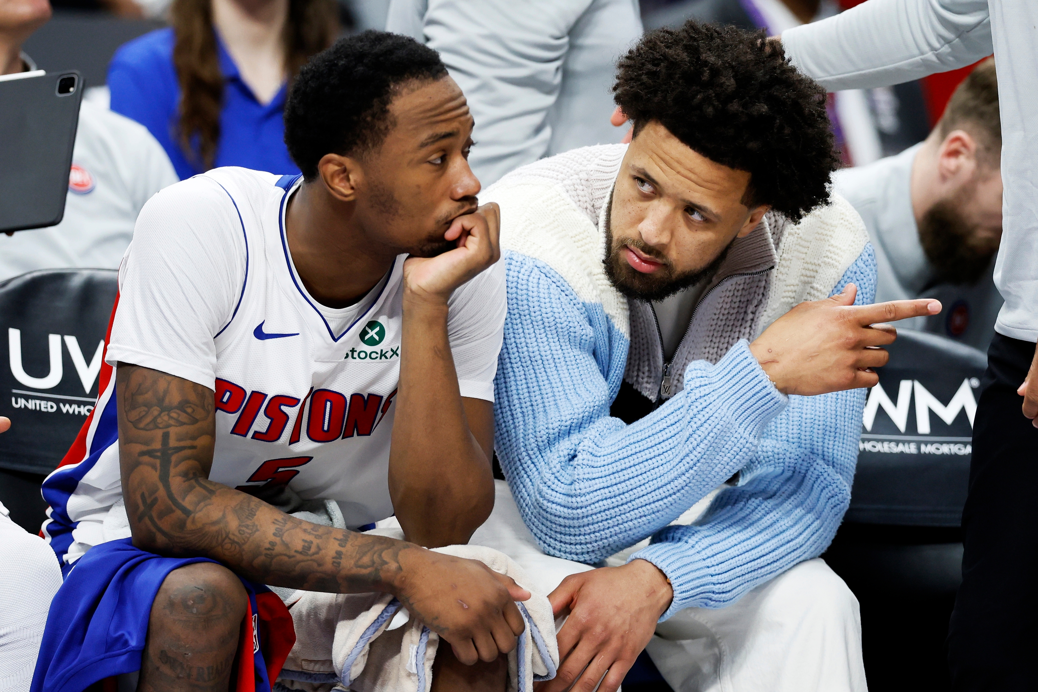 Detroit Pistons forward Ronald Holland II (5) talks with guard Cade Cunningham (2), who did not play due to an injury, during the second half of an NBA basketball game against the Toronto Raptors Tuesday, March 31, 2026, in Detroit. (AP Photo/Duane Burleson)