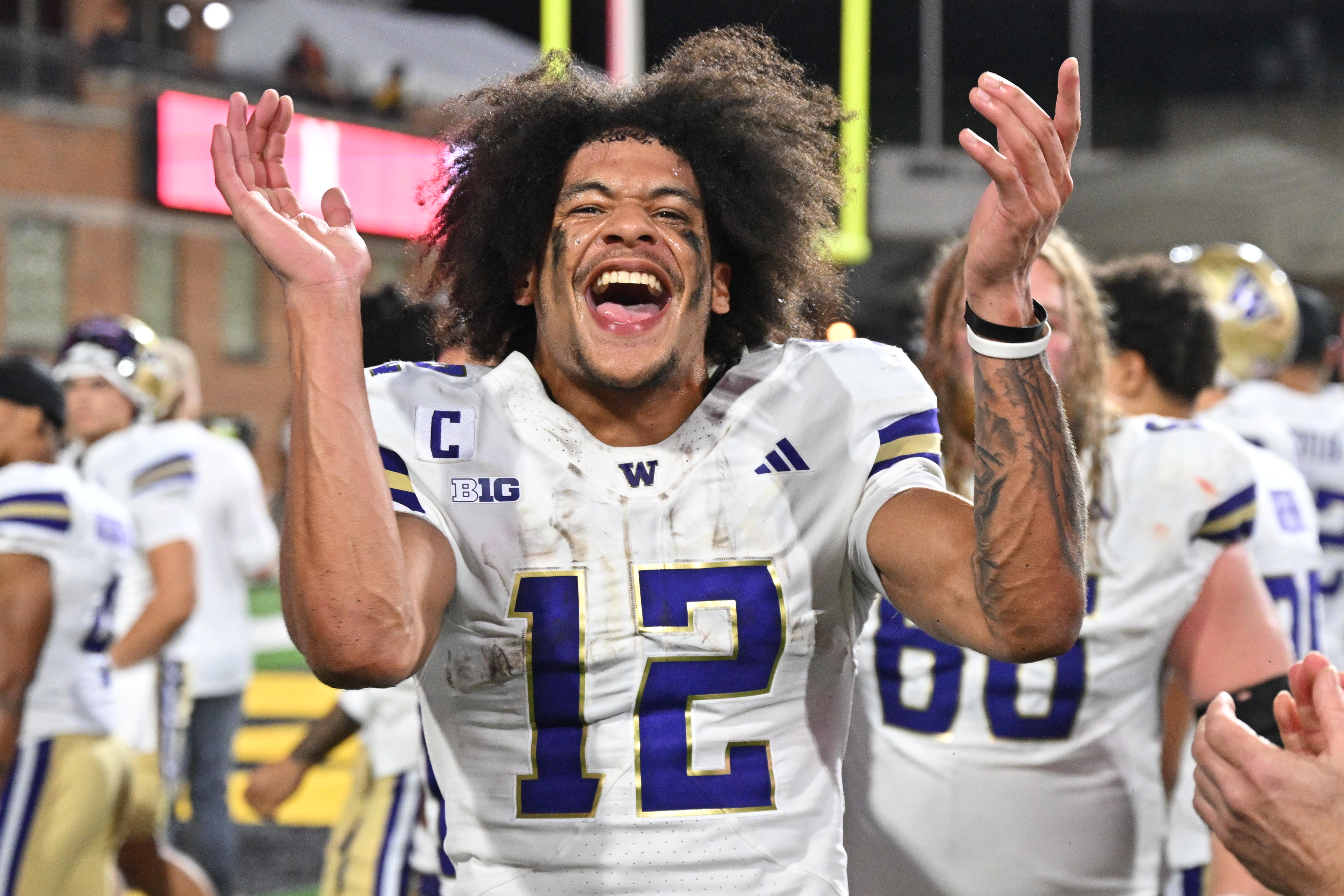 Oct 4, 2025; College Park, Maryland, USA;  Washington Huskies wide receiver Denzel Boston (12) celebrates after the Huskies comeback victory over the Maryland Terrapins at SECU Stadium. Mandatory Credit: Jamie Sabau-Imagn Images