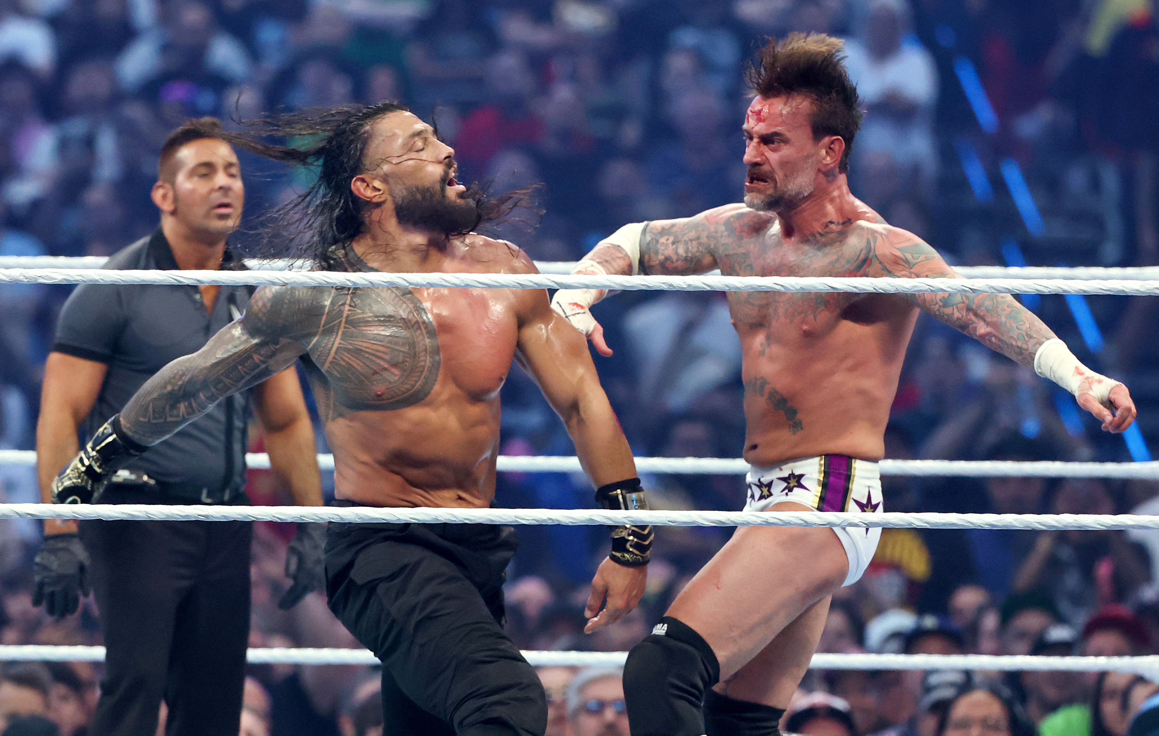 LAS VEGAS, NEVADA - APRIL 19: Roman Reigns (L) and CM Punk fight during their World Heavyweight Championship match during WrestleMania 42 at Allegiant Stadium on April 19, 2026 in Las Vegas, Nevada. (Photo by Ethan Miller/Getty Images)
