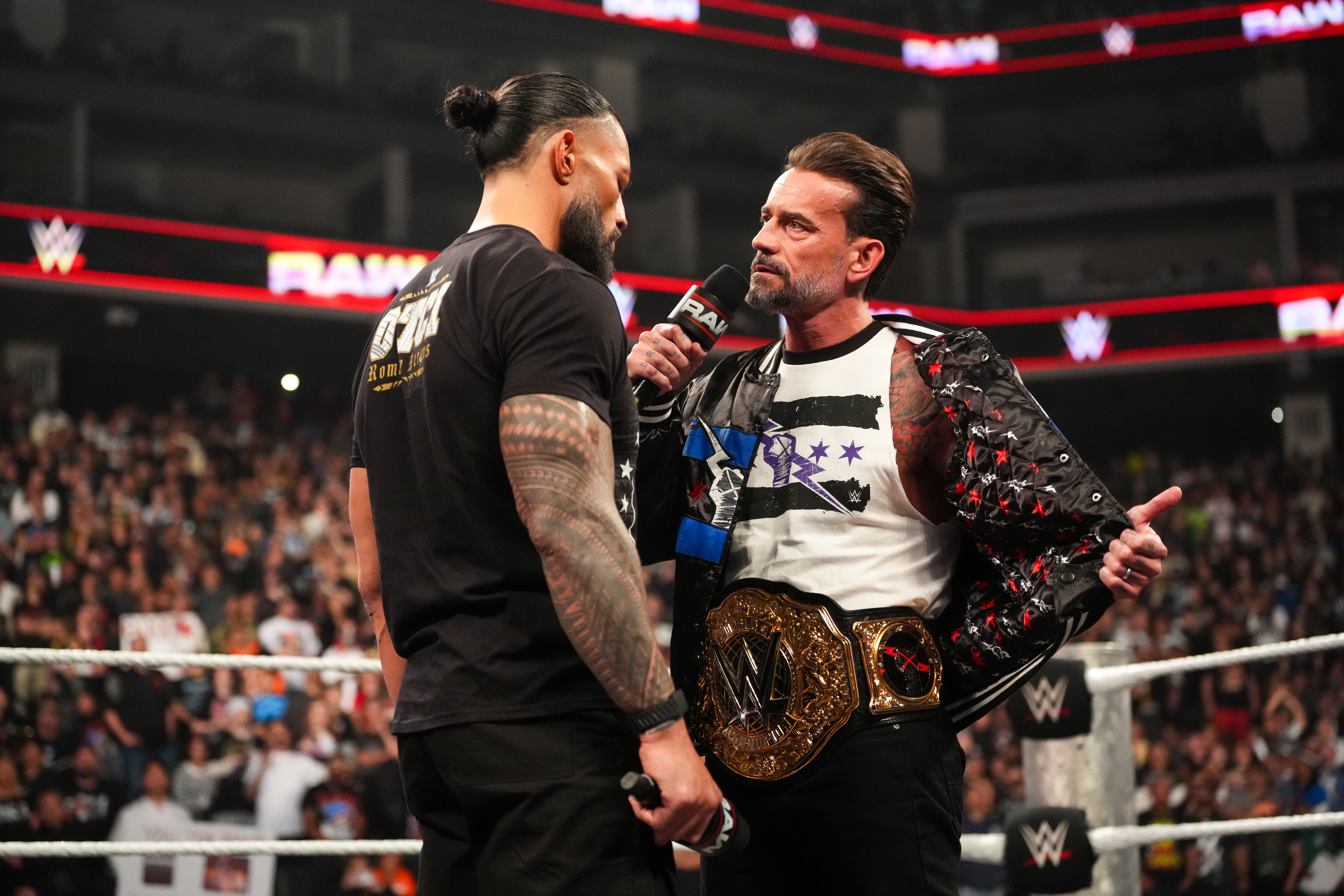 SACRAMENTO, CALIFORNIA - APRIL 13: Roman Reigns and CM Punk face off during Monday Night RAW at Golden 1 Center on April 13, 2026 in Sacramento, California.  (Photo by Rich Freeda/WWE via Getty Images)