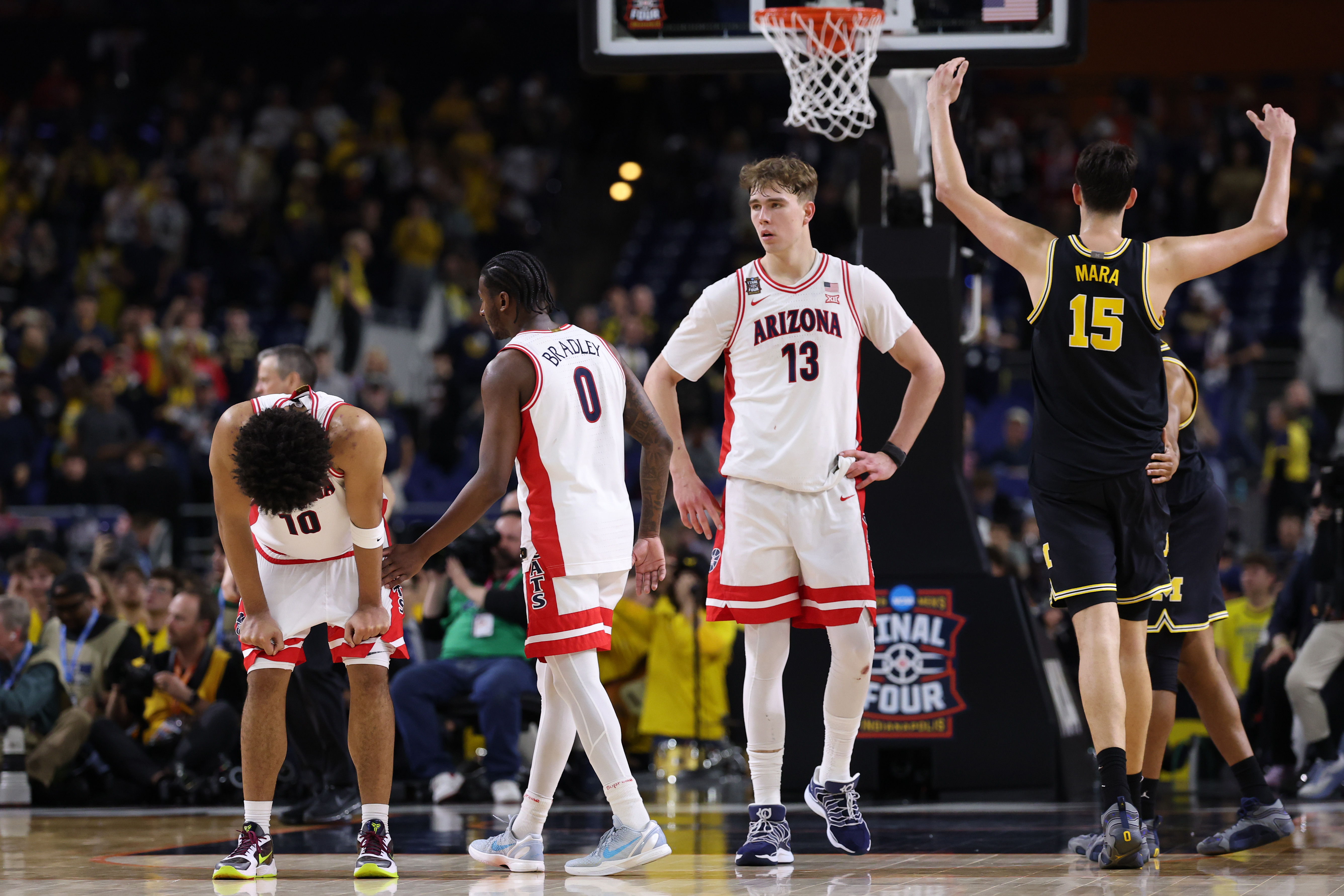INDIANAPOLIS, INDIANA - APRIL 04: Koa Peat #10 and Jaden Bradley #0 of the Arizona Wildcats react after losing to the Michigan Wolverines in the Final Four of the 2026 NCAA Men's Basketball Tournament at Lucas Oil Stadium on April 04, 2026 in Indianapolis, Indiana. (Photo by Michael Reaves/Getty Images)