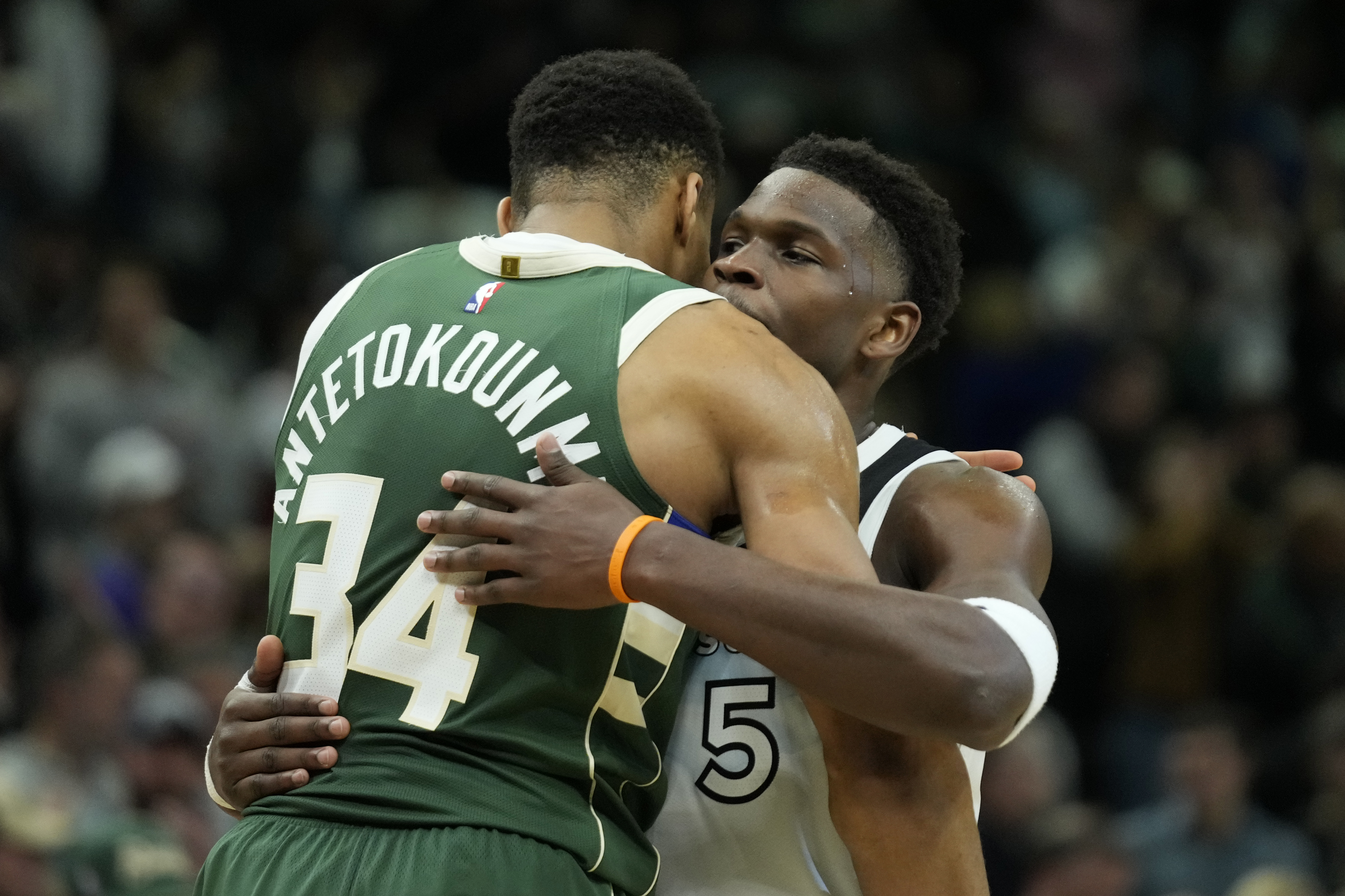 Milwaukee Bucks' Giannis Antetokounmpo hugs Minnesota Timberwolves' Anthony Edwards after an NBA basketball game Tuesday, April 8, 2025, in Milwaukee. (AP Photo/Aaron Gash)