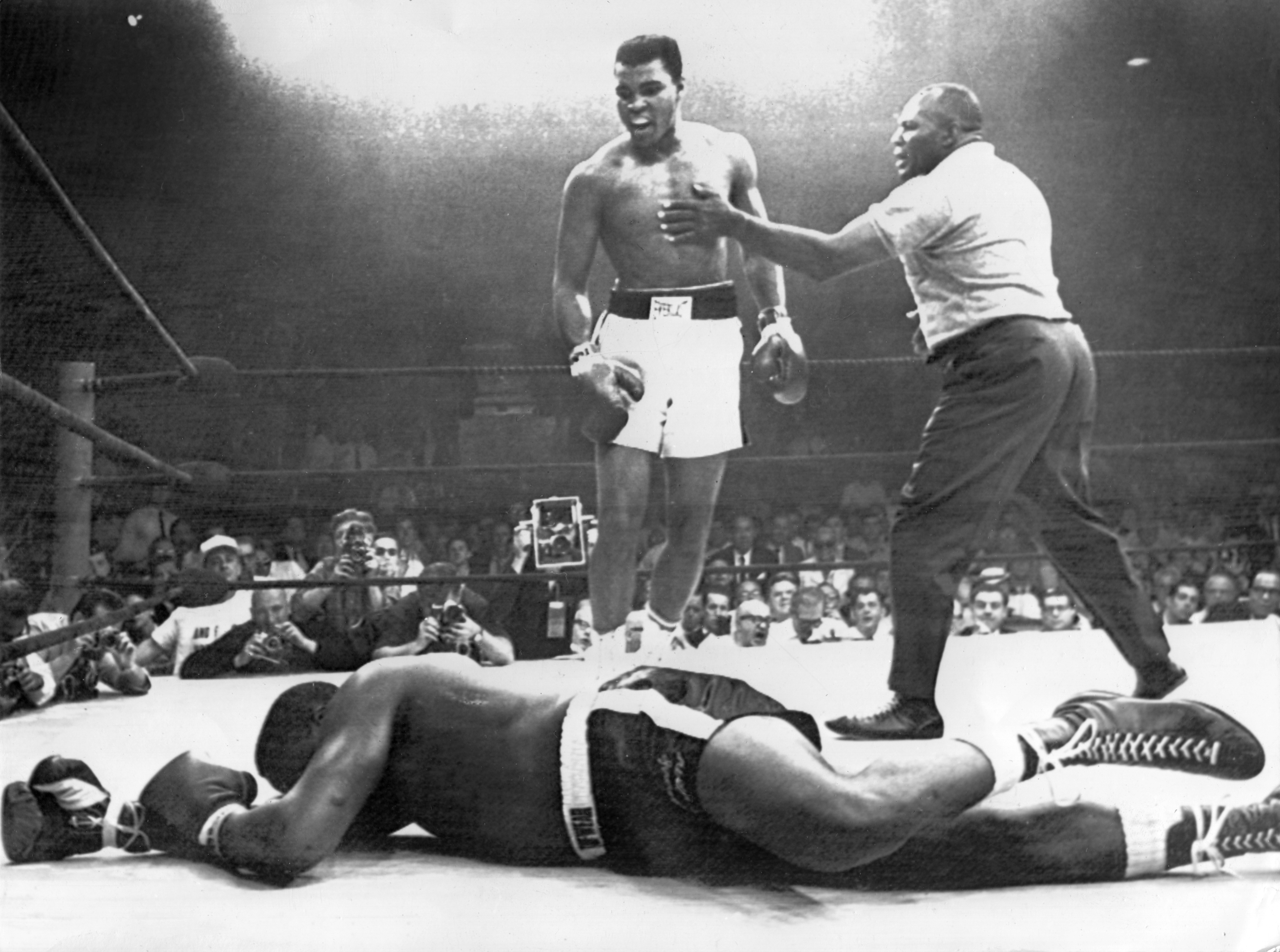 Scene of one of the shortest heavyweight championship box fights between defending champion Muhammad Ali (centre, former Cassius Clay) and challenger Charles "Sonny" Liston (on the floor) on 25 May 1965 in Lewiston, Maine. To the right referee Walcott. Cas (Photo by Schulman-Sachs/picture alliance via Getty Images)