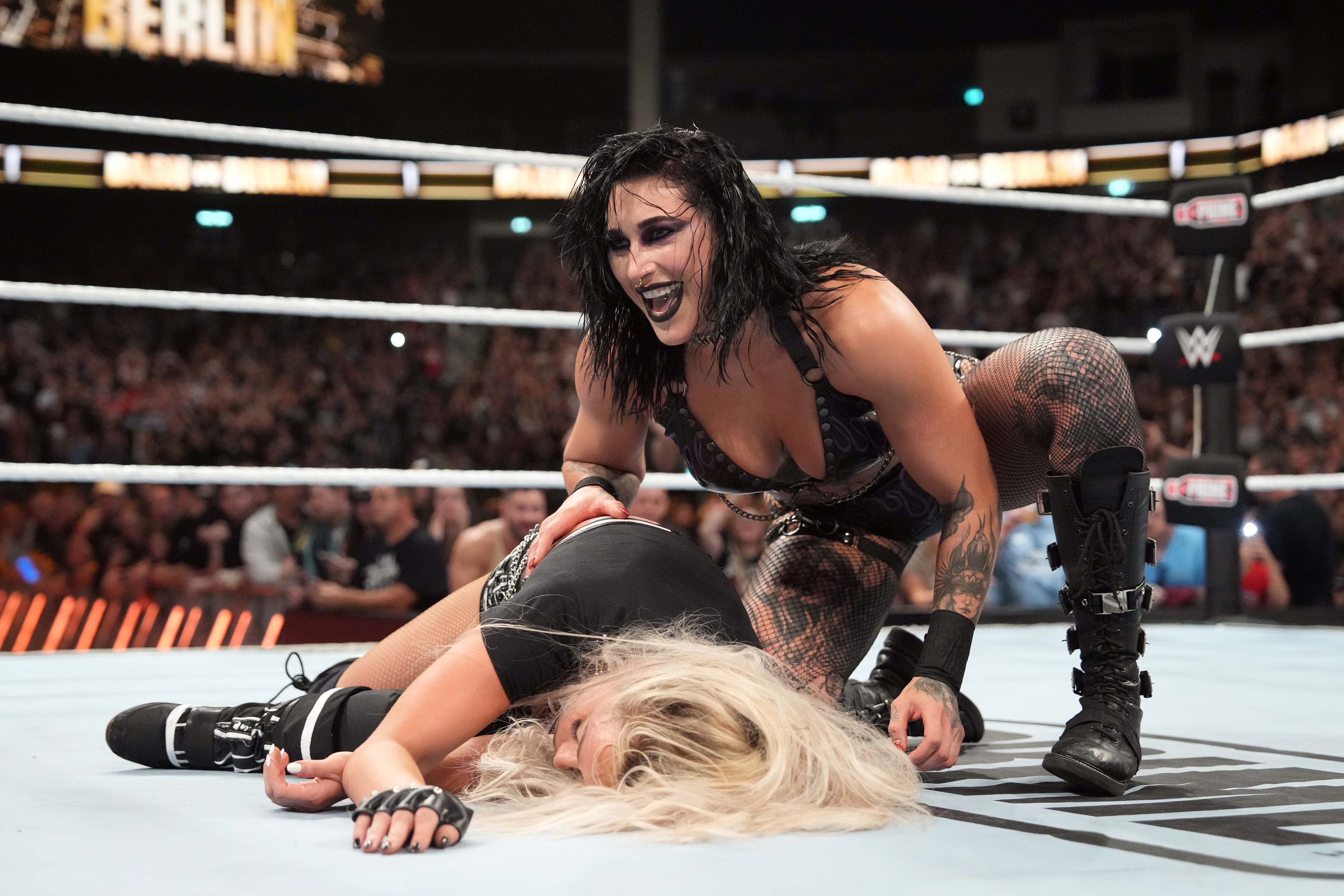 BERLIN, GERMANY - AUGUST 31: Rhea Ripley kneels over WWE Women's World Champion Liv Morgan after Ripley pinned her during the WWE Bash in Berlin Premium Live Event at Uber Arena on August 31, 2024 in Berlin, Germany.  (Photo by WWE/Getty Images)