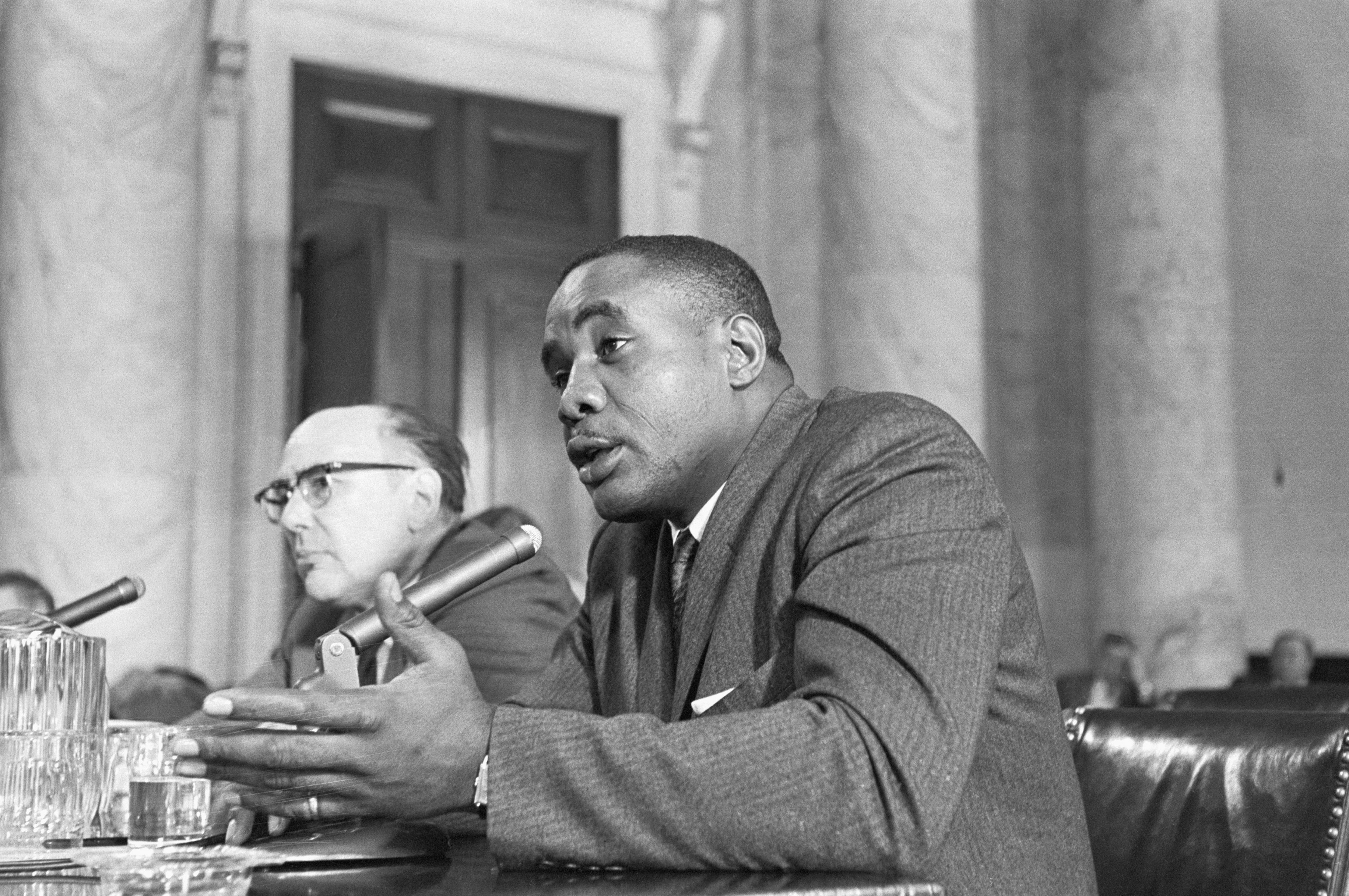 (Original Caption) 12/13/1960-Washington, D.C.- Top-ranking heavyweight contender Sonny Liston is shown today as he told Senate boxing investigators that a St. Louis police officer once told him "If I wanted to stay alive to leave St. Louis or they would find me in an alley." Liston's attorney, Jacob Kossman, is shown seated at left.