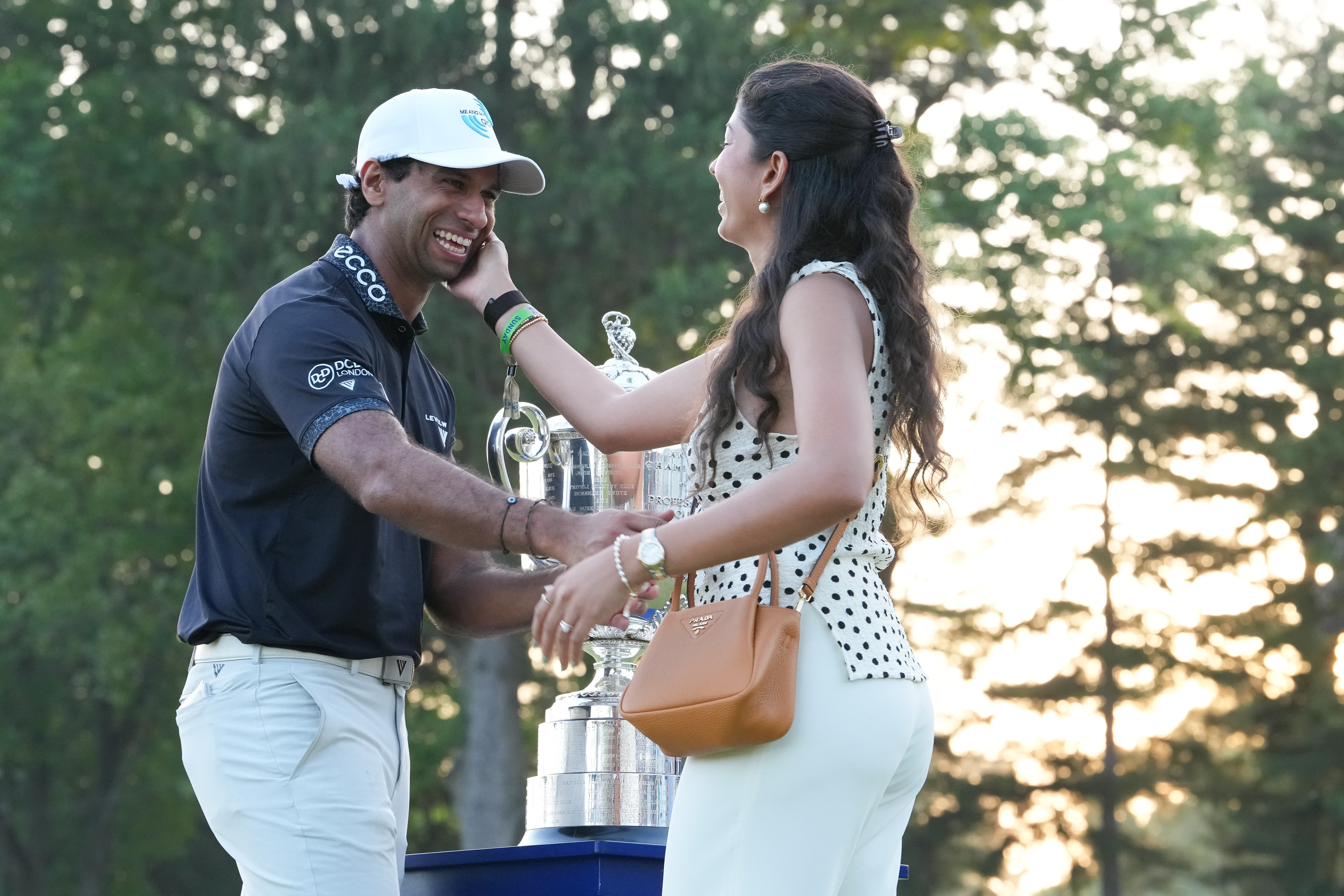NEWTON SQUARE, PENNSYLVANIA - MAY 17: Aaron Rai of England and his wife, Gaurika Bishnoi, are seen together, with the Wanamaker Trophy, after the final round of PGA Championship at Aronimink Golf Club on May 17, 2026 in Newtown Square, Pennsylvania. (Photo by Ben Jared/PGA TOUR via Getty Images)