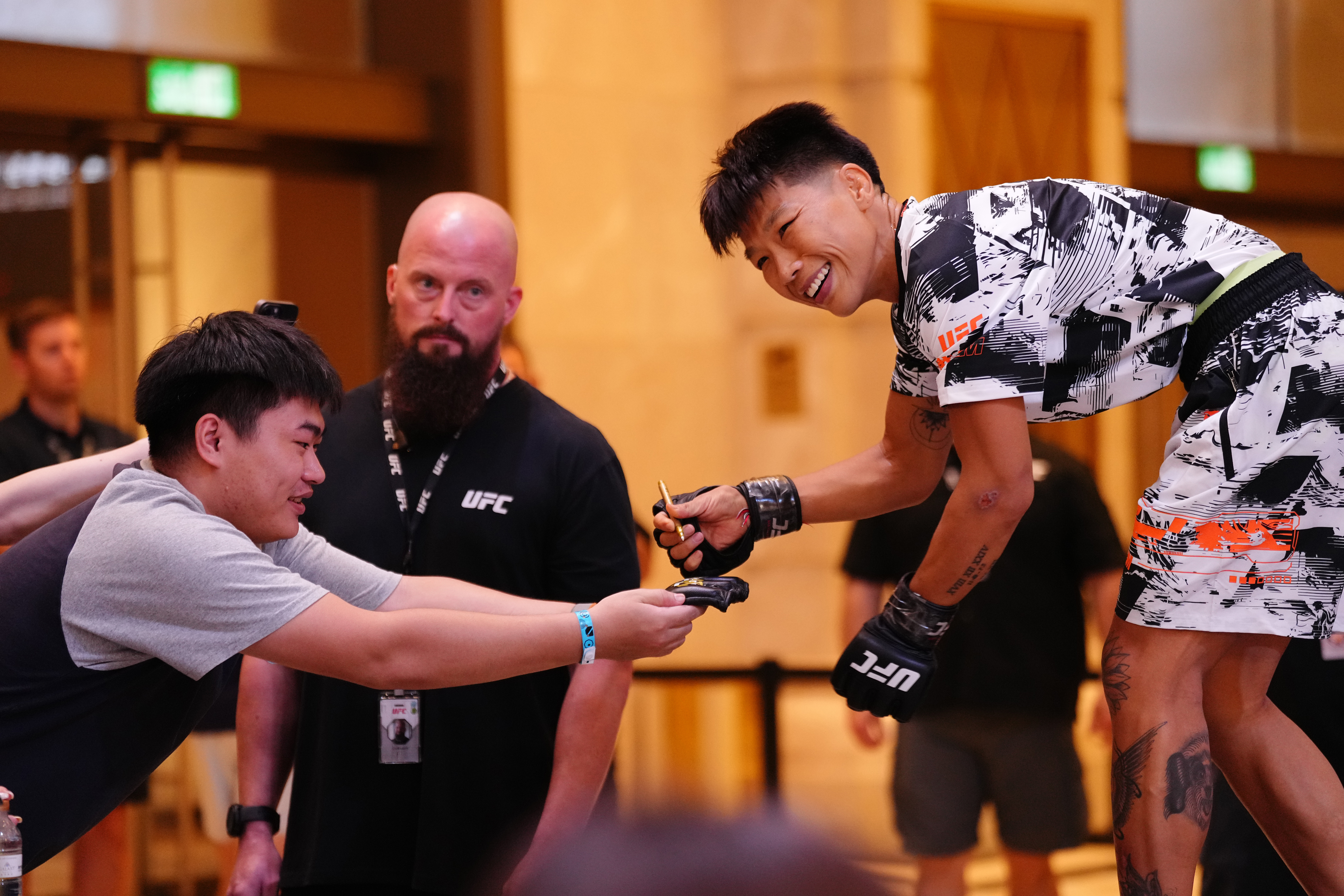 MACAU, CHINA - MAY 27: Xiong Jingnan of China signs an autograph for a fan during the UFC Fight Night open workouts at Galaxy Promenade East Square on May 27, 2026 in Macau, China.  (Photo by Jeff Bottari/Zuffa LLC)