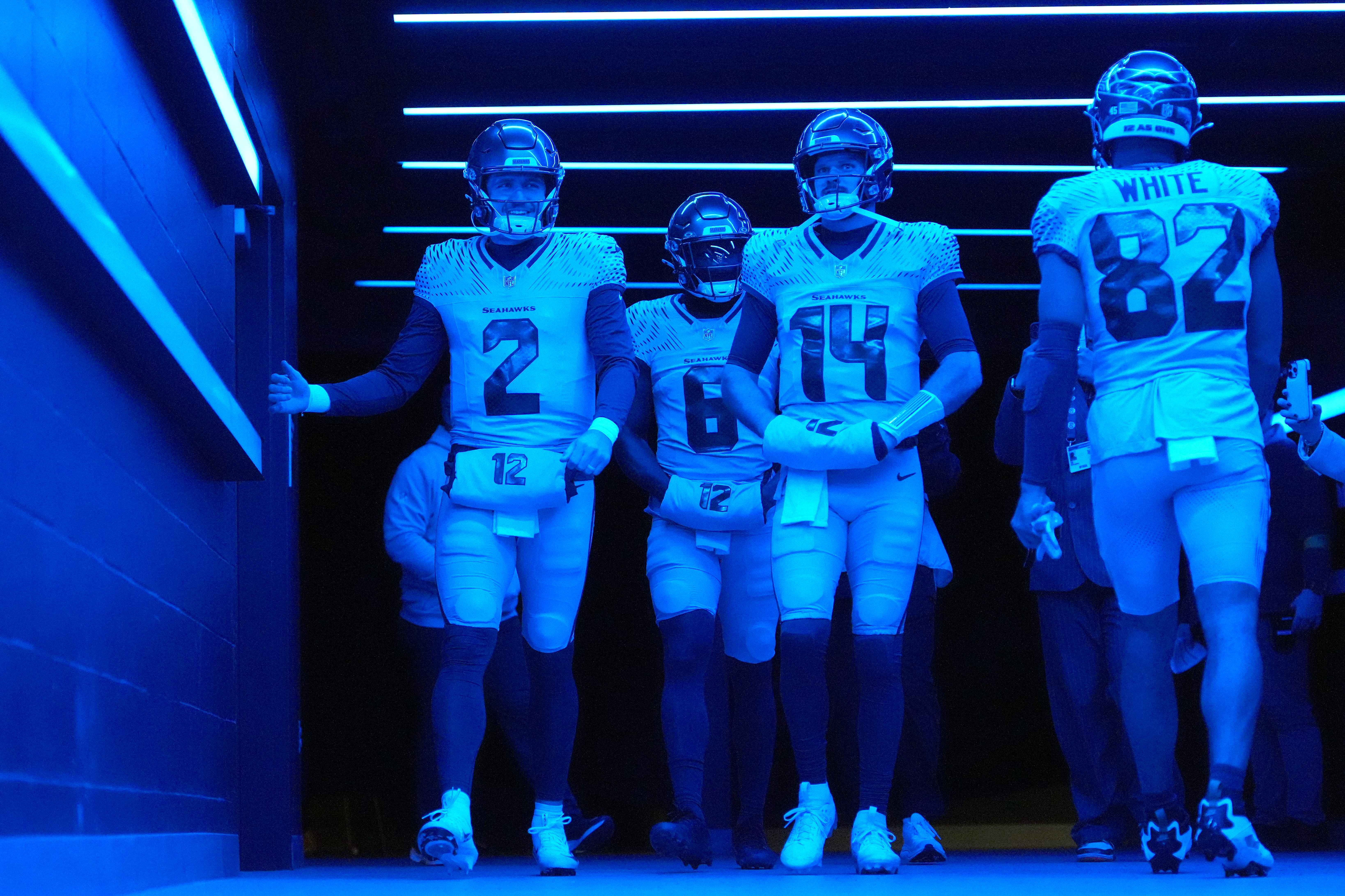 SEATTLE, WASHINGTON - DECEMBER 18: Drew Lock #2, Jalen Milroe #6 and Sam Darnold #14 of the Seattle Seahawks walk out of the tunnel for warmups before the game against the Los Angeles Rams at Lumen Field on December 18, 2025 in Seattle, Washington. (Photo by Soobum Im/Getty Images)