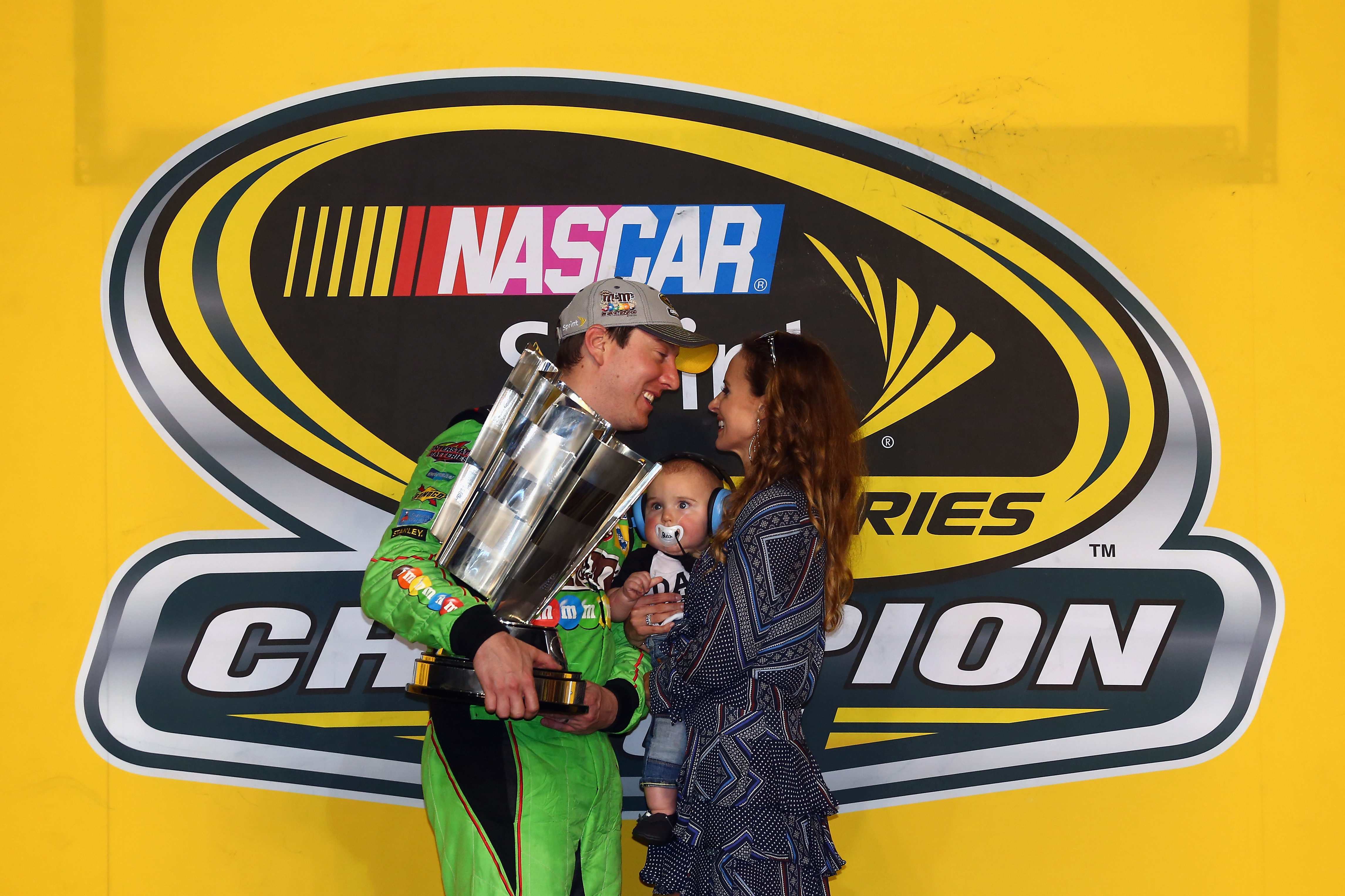 HOMESTEAD, FL - NOVEMBER 22:  Kyle Busch, driver of the #18 M&M's Crispy Toyota, celebrates with his son Brexton and wife Samantha in Victory Lane after winning the series championship and the NASCAR Sprint Cup Series Ford EcoBoost 400 at Homestead-Miami Speedway on November 22, 2015 in Homestead, Florida.  (Photo by Sarah Crabill/Getty Images)