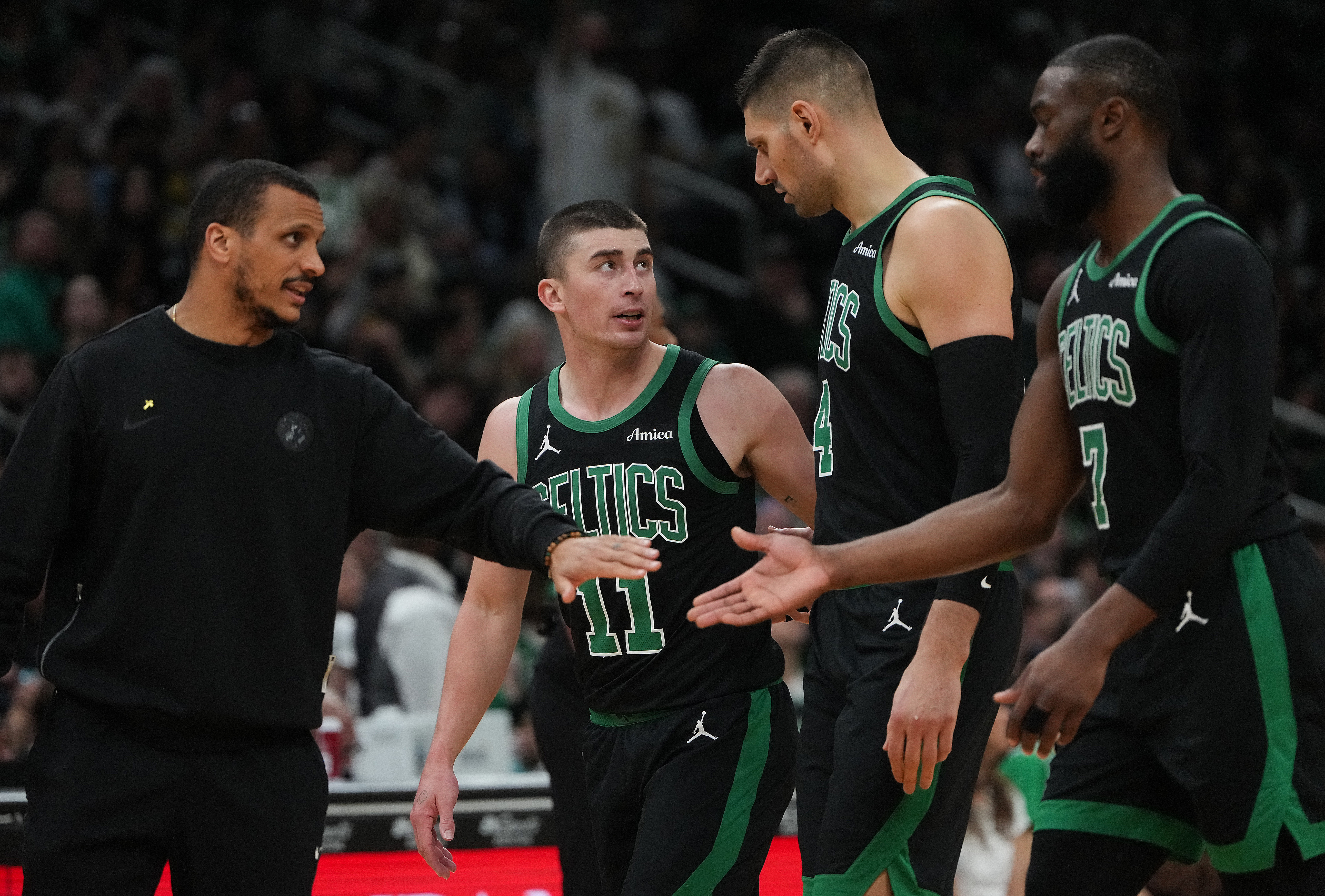 Boston, MA - April 10: Boston Celtics head coach Joe Mazzulla, Payton Pritchard, Nikola Vuevi and Jaylen Brown head to the bench for a timeout in the first quarter. The Celtics played the New Orleans Pelicans at TD Garden on April 10, 2026. (Photo by Barry Chin/The Boston Globe via Getty Images)