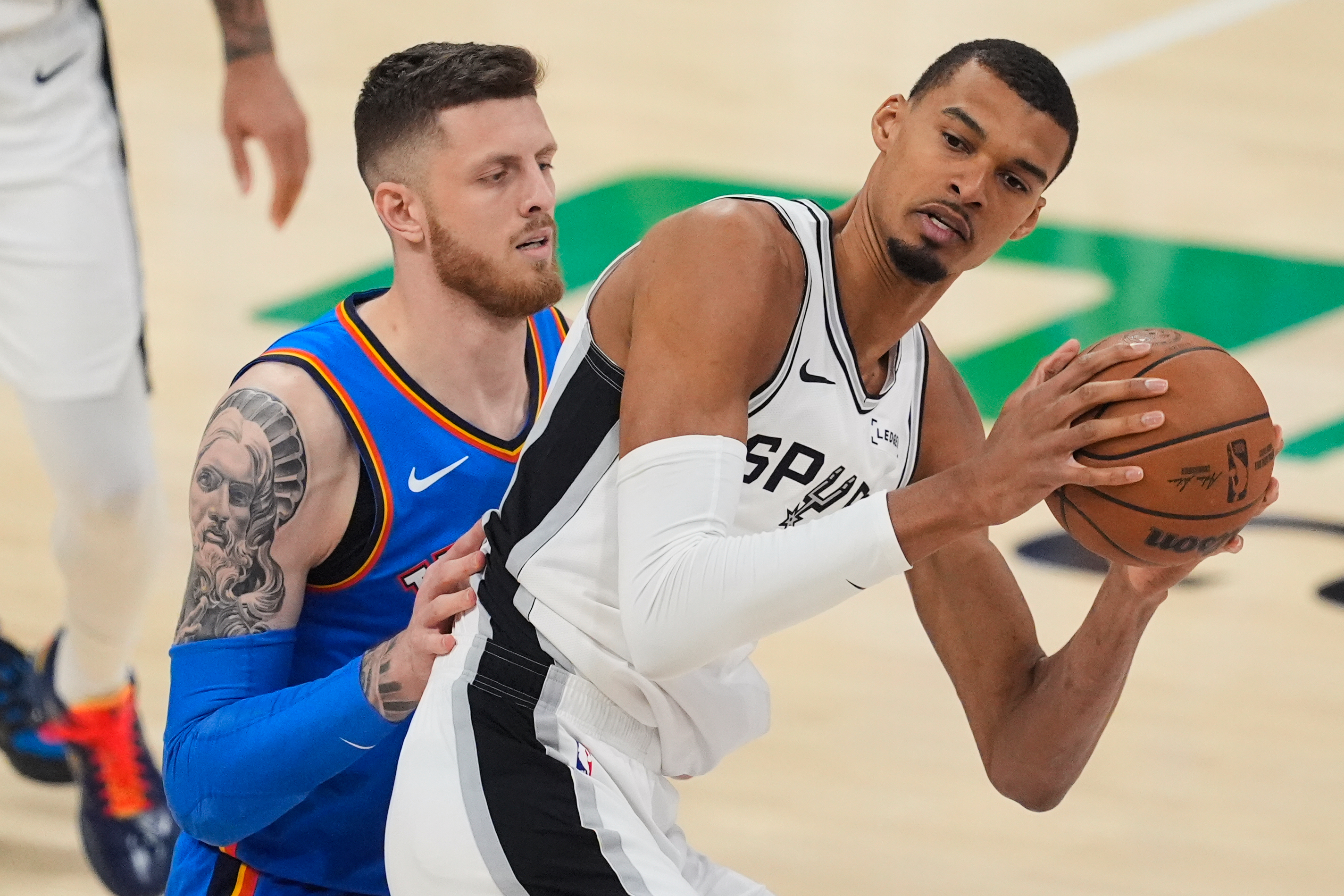 Oklahoma City Thunder center Isaiah Hartenstein (55) defends against San Antonio Spurs forward Victor Wembanyama (1) during the first half of Game 2 in the Western Conference finals NBA basketball playoffs series Wednesday, May 20, 2026, in Oklahoma City. (AP Photo/Tony Gutierrez)