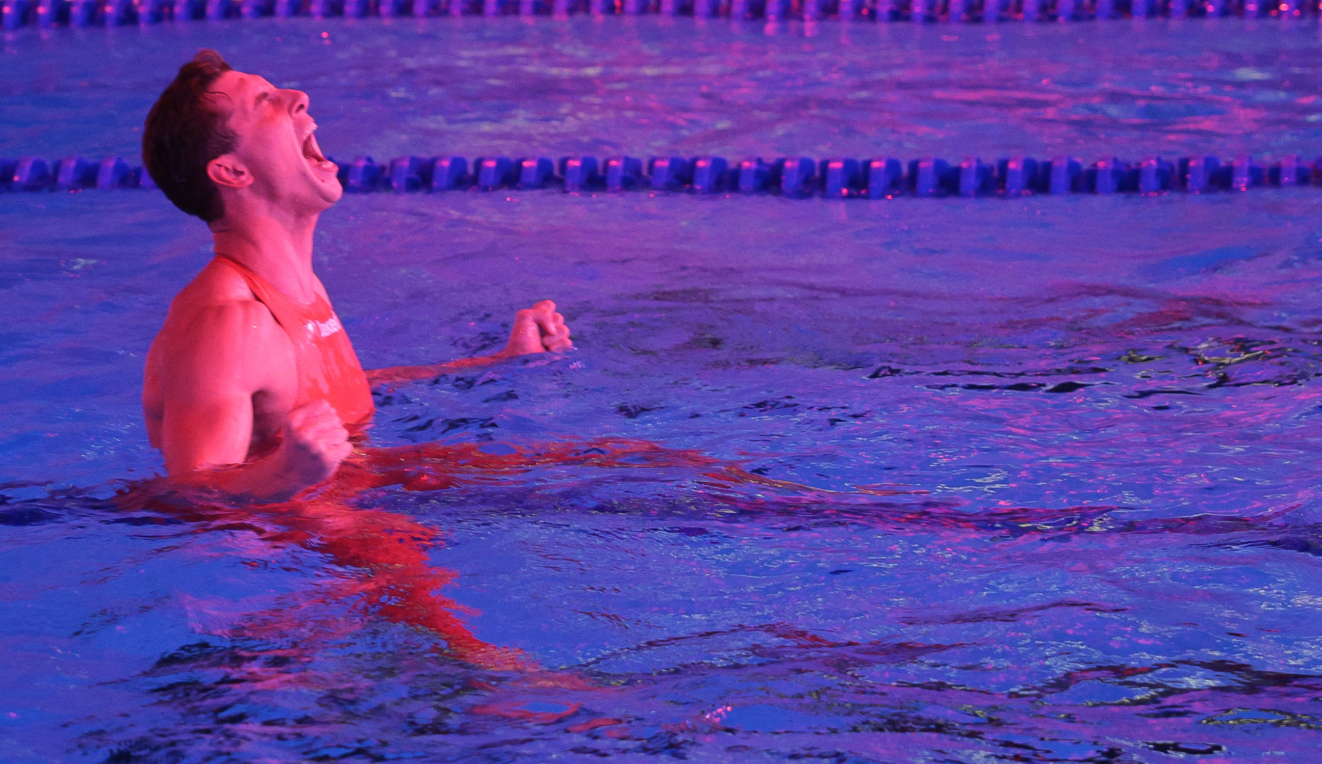 Greek swimmer Kristian Gkolomeev reacts after beating the men's 50m freestyle world record during the Enhanced Games at Resorts World in Las Vegas, Nevada, on May 24, 2026. The first-ever Enhanced Games -- widely dubbed the "Steroid Olympics" -- take place Sunday in Las Vegas, where elite sprinters, swimmers and weightlifters will vie for world records while taking banned performance-enhancing drugs. (Photo by Etienne LAURENT / AFP via Getty Images)