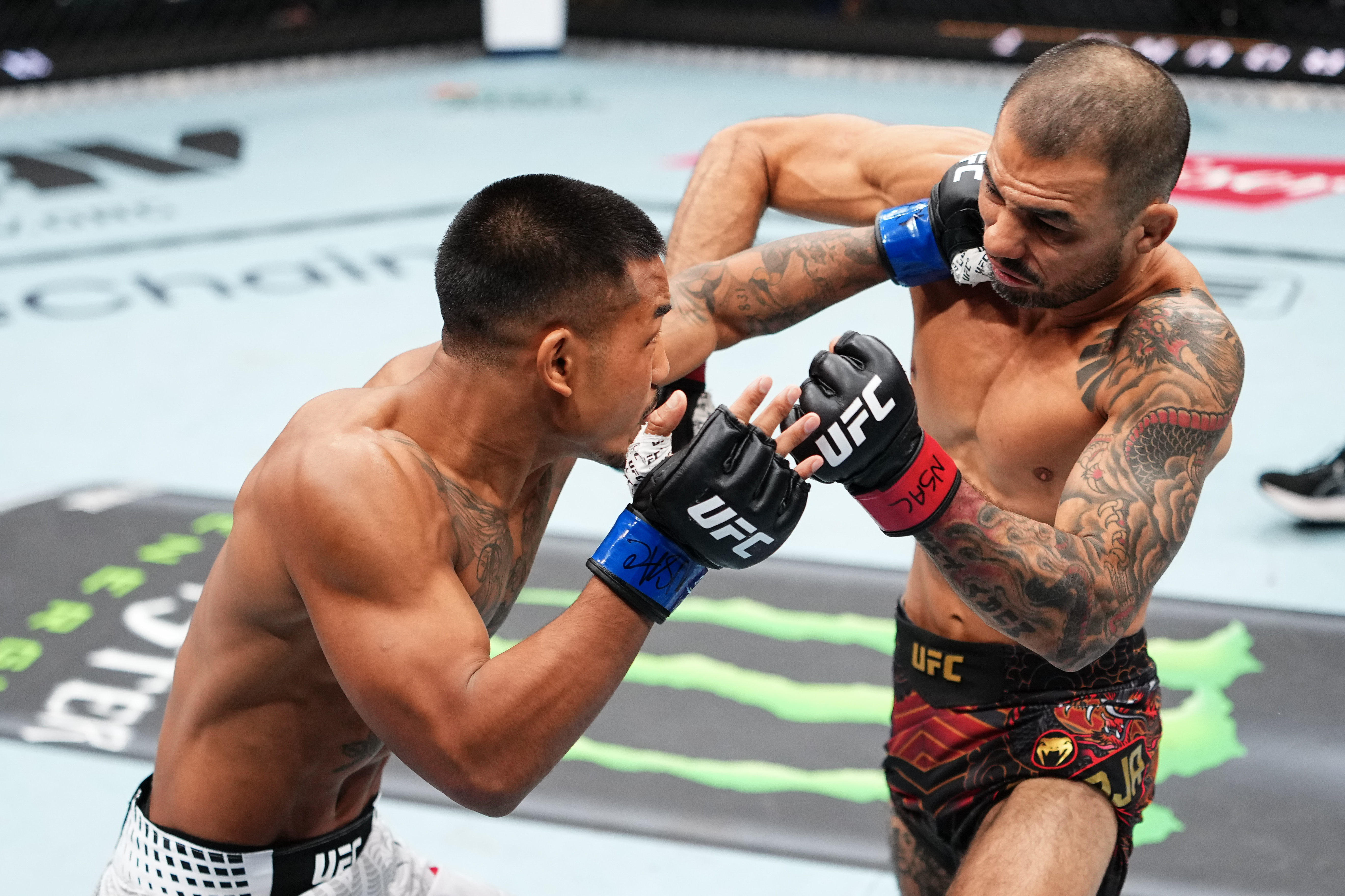 LAS VEGAS, NEVADA - DECEMBER 06: (L-R) Joshua Van of Myanmar punches Alexandre Pantoja of Brazil in the UFC flyweight championship fight during the UFC 323 event at T-Mobile Arena on December 06, 2025 in Las Vegas, Nevada. (Photo by Jeff Bottari/Zuffa LLC)