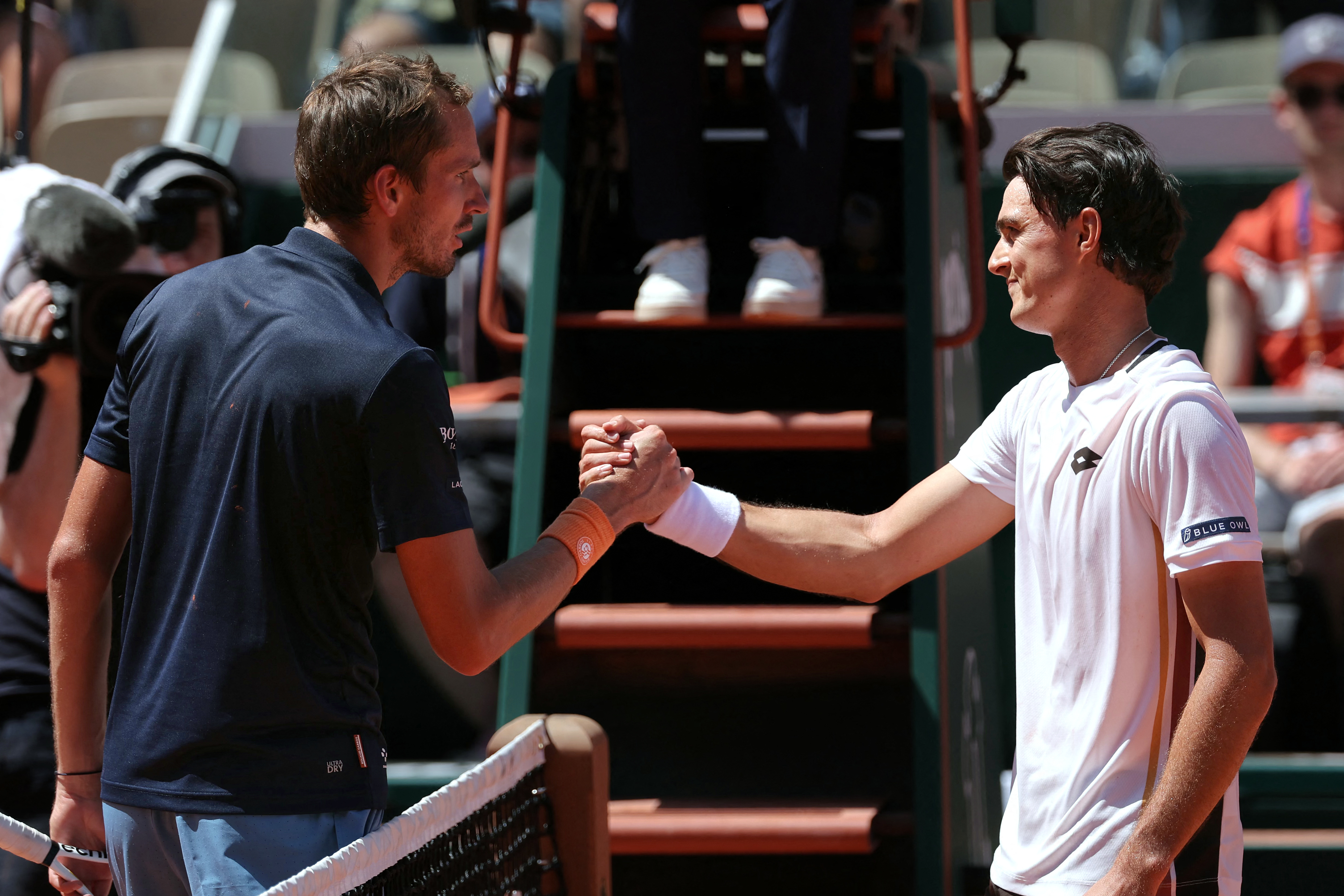 Daniil Medvedev (L) congratulates Australia's Adam Walton (R) on his victory at the end of their men's singles match on day 3 of the French Open tennis tournament on Court Suzanne-Lenglen at the Roland-Garros Complex in Paris on May 26, 2026. (Photo by Thomas SAMSON / AFP via Getty Images)