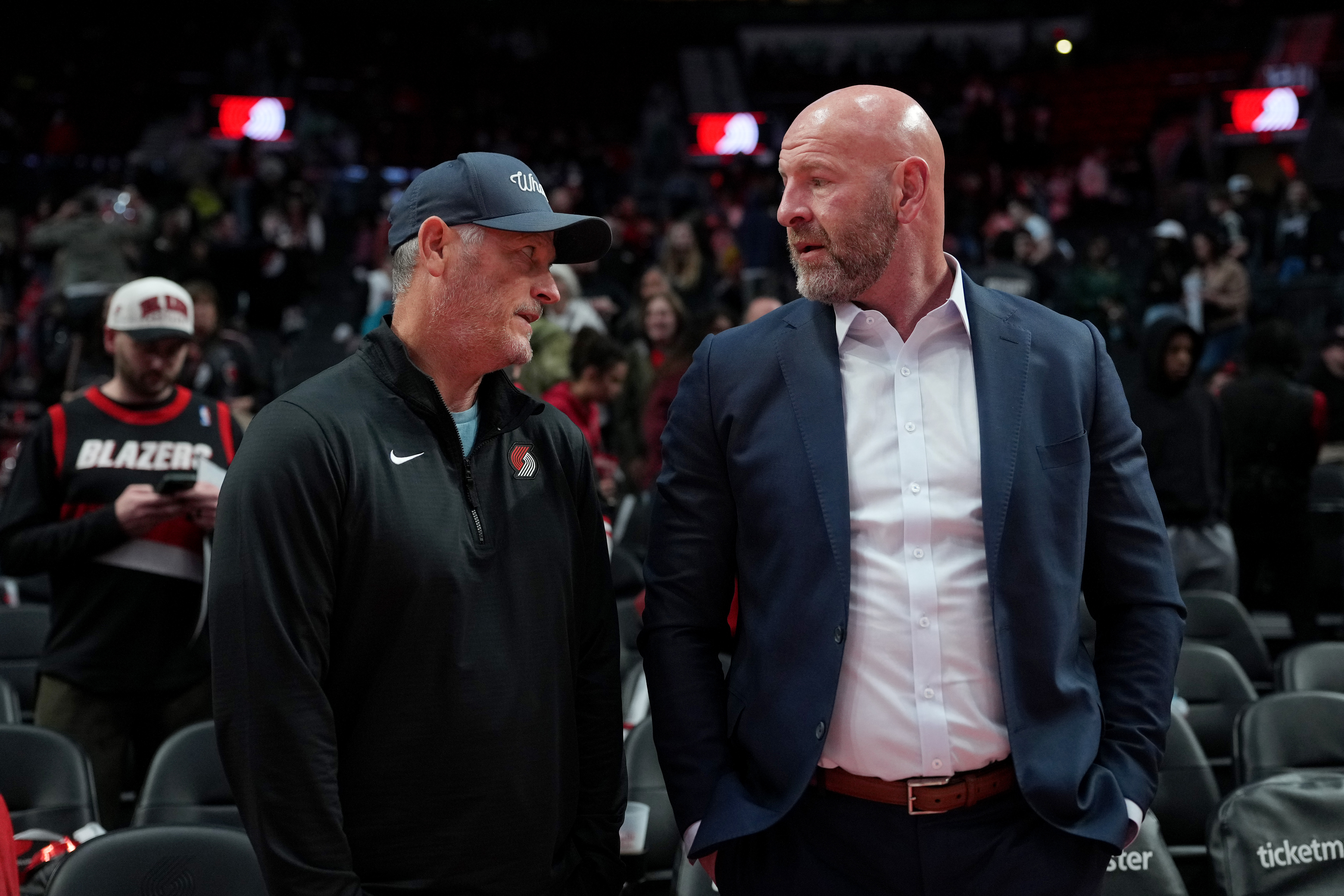 PORTLAND, OREGON - APRIL 12:  (L-R) Tom Dundon, Portland Trail Blazers owner, talks with general manager Joe Cronin after the game against the Sacramento Kings at Moda Center on April 12, 2026 in Portland, Oregon. NOTE TO USER: User expressly acknowledges and agrees that, by downloading and or using this photograph, User is consenting to the terms and conditions of the Getty Images License Agreement.  (Photo by Soobum Im/Getty Images)