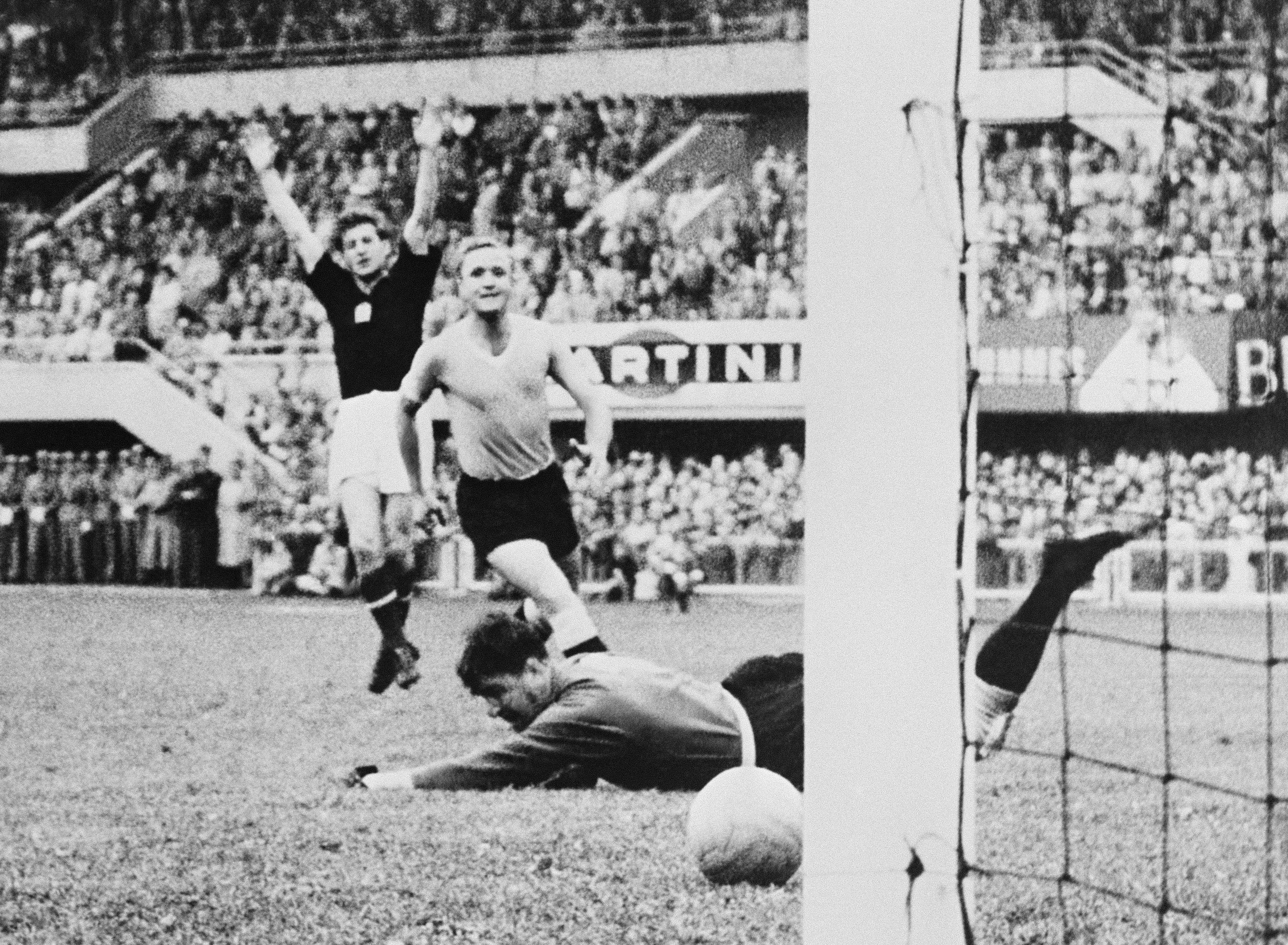 Hungarian forward Sandor Kocsis (L) celebrates as the ball rolls past Uruguayan goalkeeper Gaston Roque Maspoli into the net for a goal as defender Jose Santamaria looks on 30 June 1954 in Lausanne during the World Cup semifinal match between Hungary and Uruguay. Hungary advanced to the final with a 4-2 victory in extra time. (Photo by AFP via Getty Images)